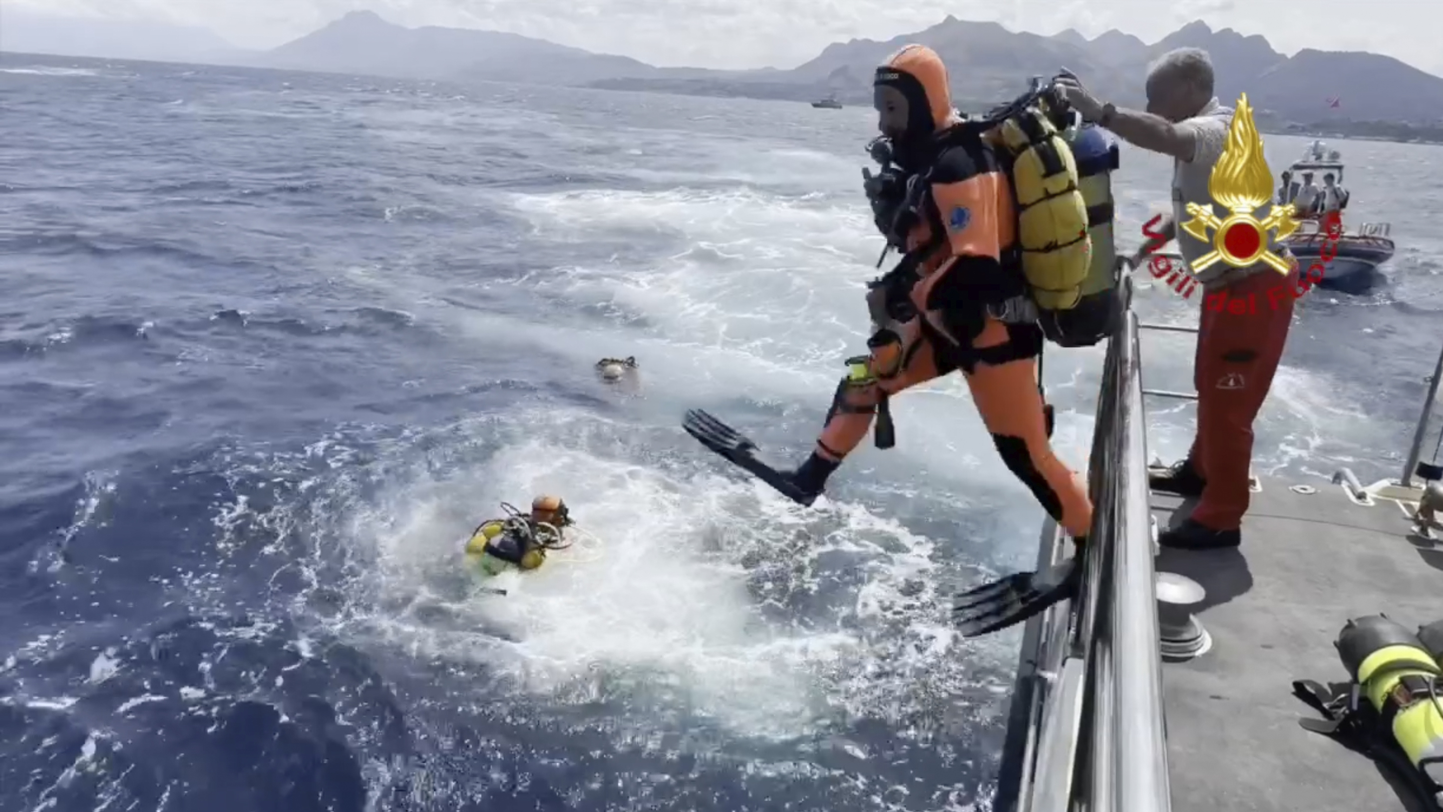 Rescue teams and divers returned to the site of a storm-sunken superyacht