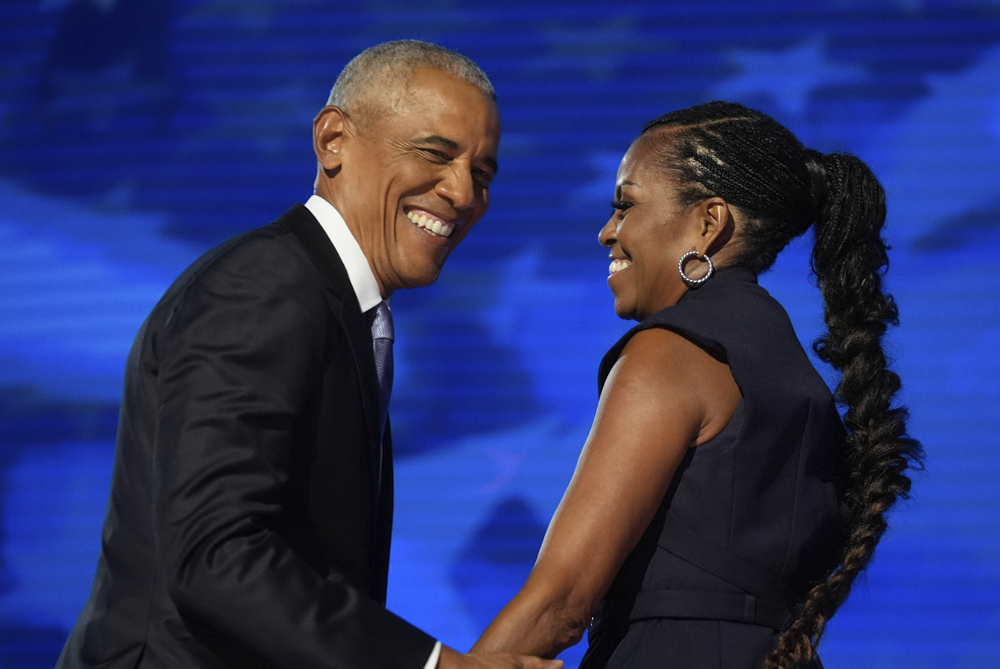 Former President Barack Obama hugs former first lady Michelle Obama