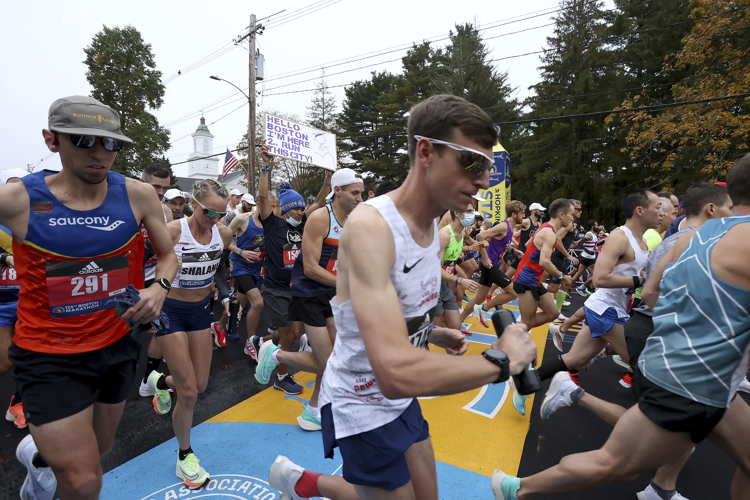 Runners including Shalane Flanagan, second from left, cross the starting line of the 125th Boston Marathon