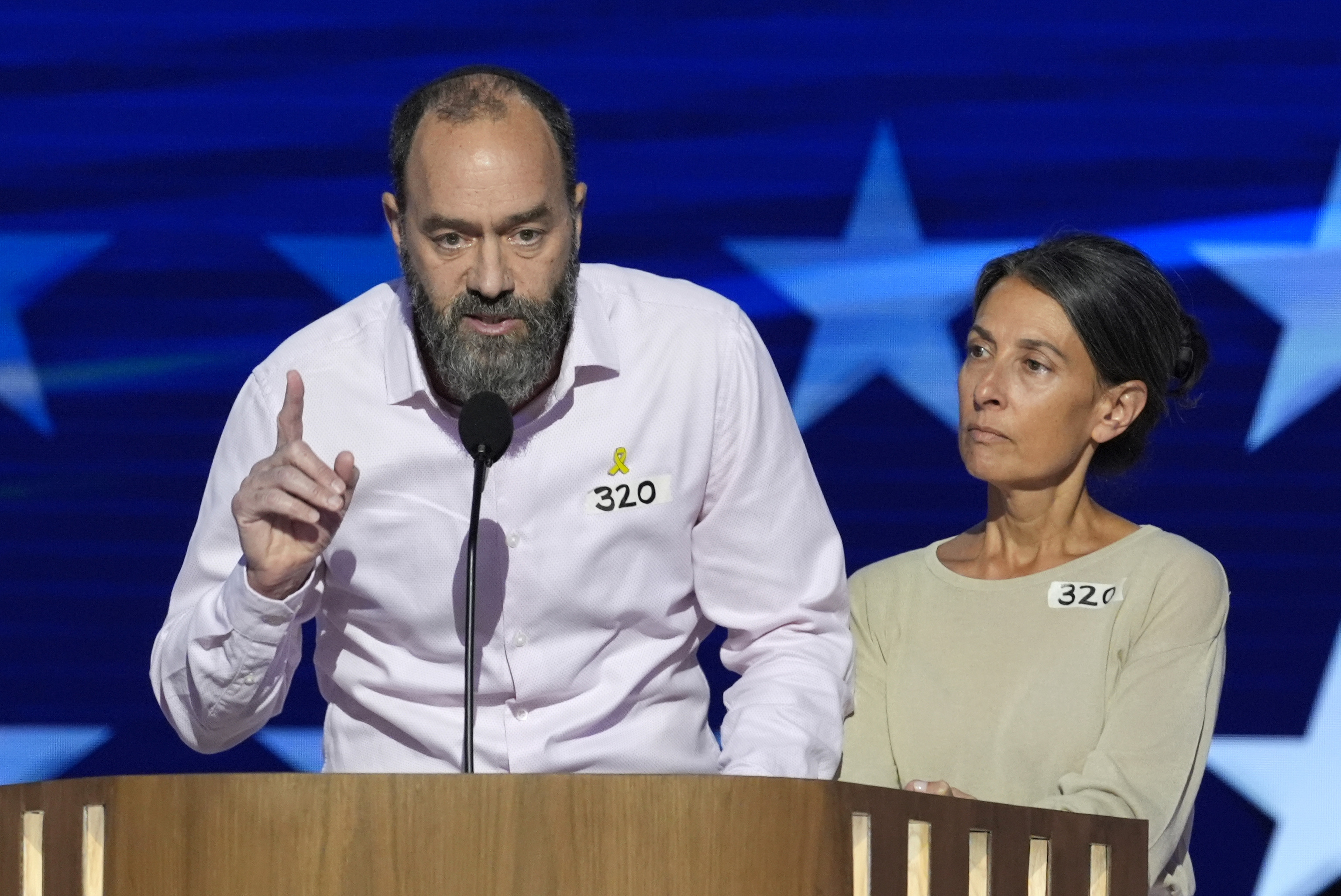 Jon Polin, left, and Rachel Goldberg, parents of Hersh Goldberg-Polin, speak on stage during the Democratic National Convention