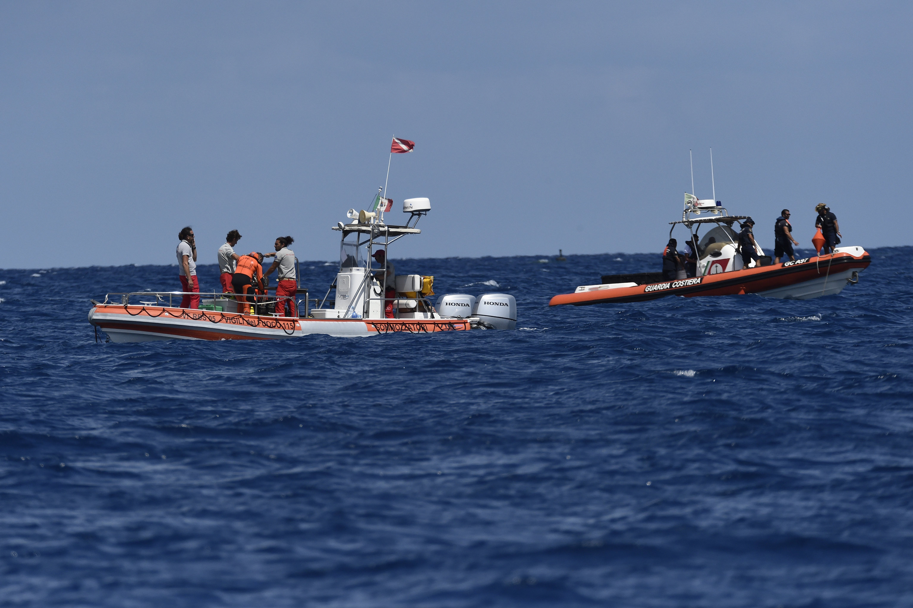 Rescue teams and divers returned to the site of a storm-sunken superyacht Tuesday to search for six people, including British tech magnate Mike Lynch