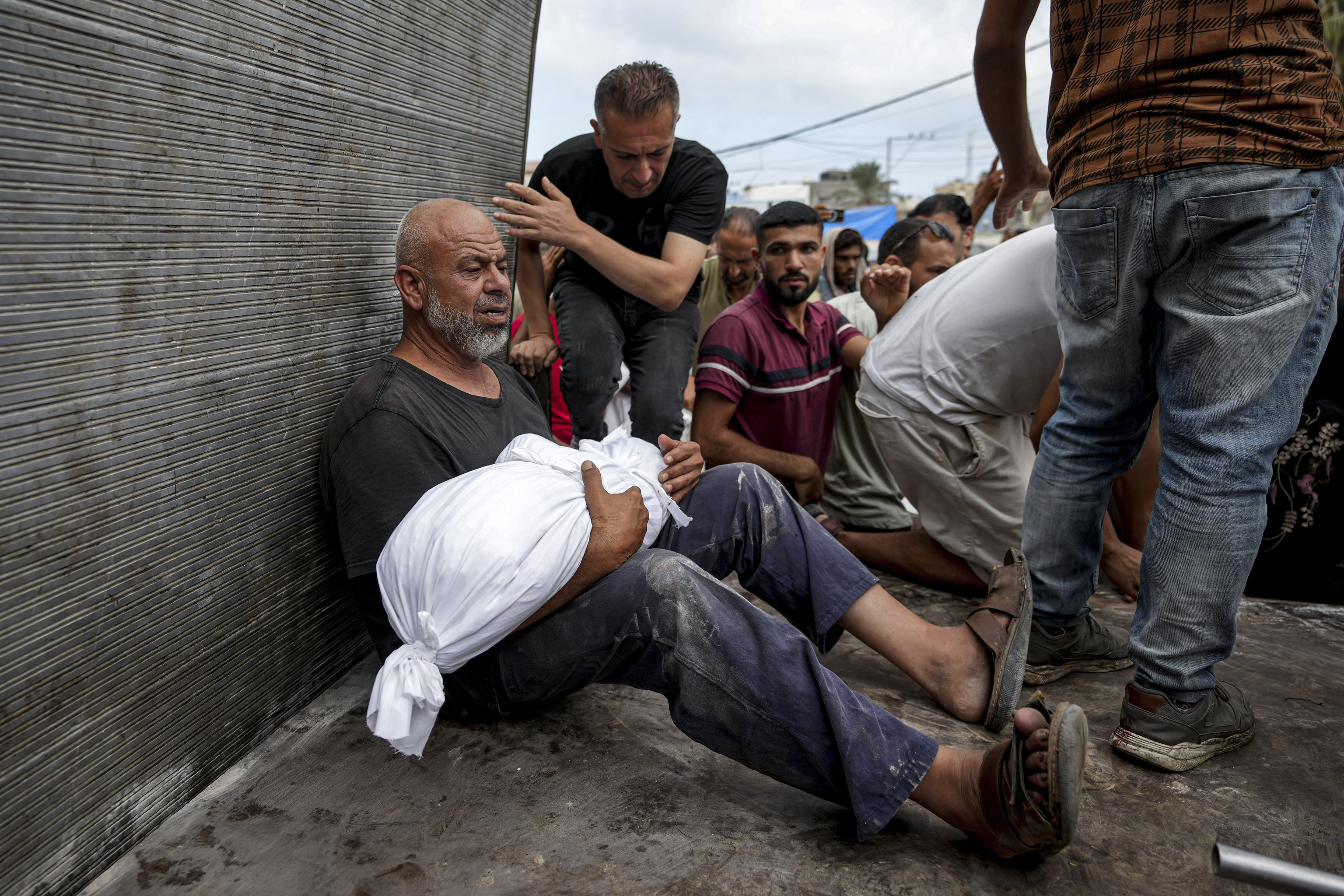 Palestinians pray next to the bodies of their relatives killed in the Israeli bombardment of the Gaza Strip