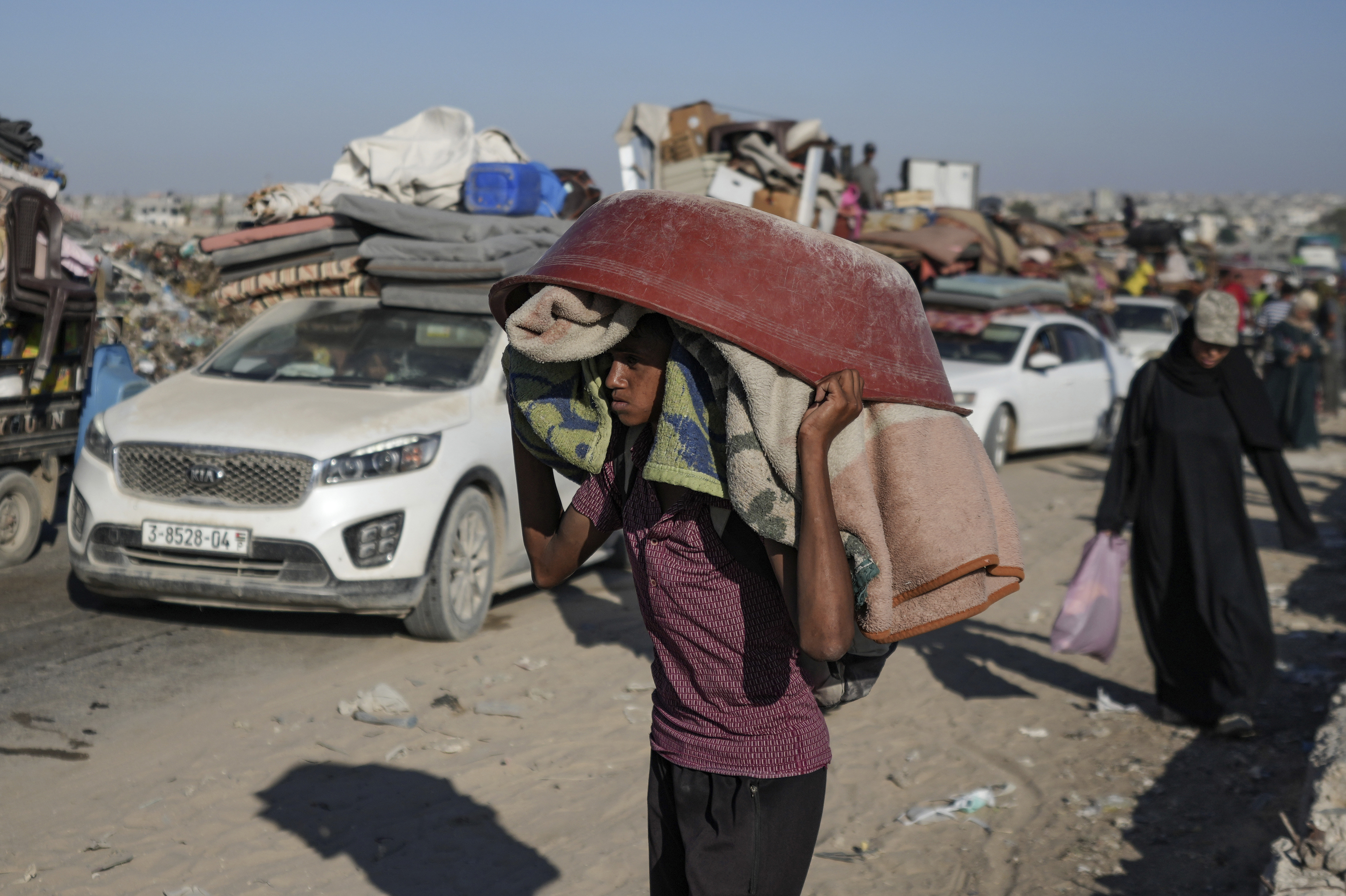 A Palestinian youth flees the Khan Younis area of the Gaza Strip, following Israeli military evacuation orders