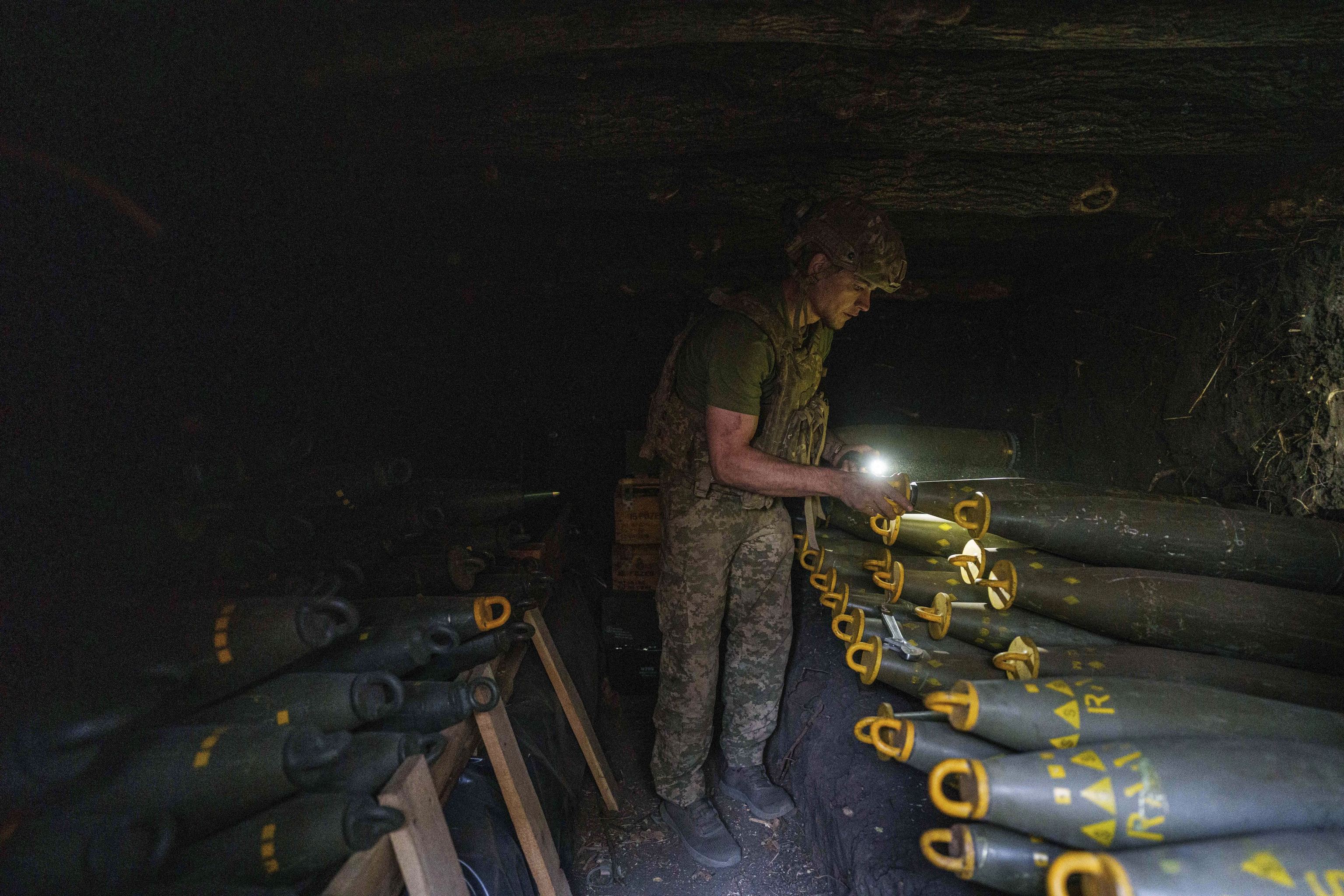 Ukrainian serviceman Oleh of 148th separate artillery brigade of the Air Assault Forces prepares 155mm artillery