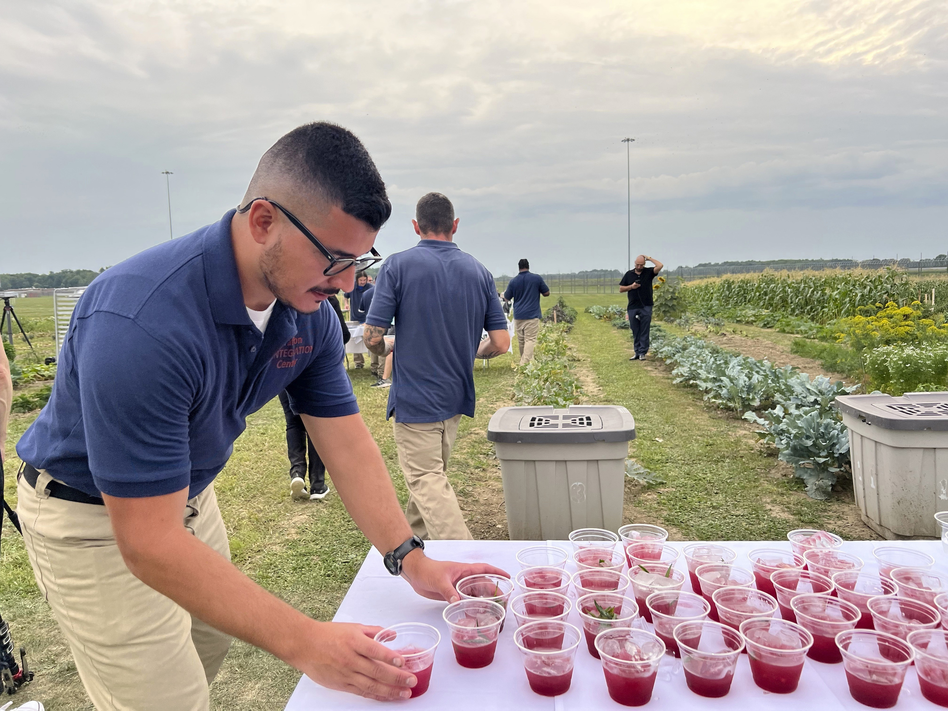 Efrain Paniagua-Villa, 28, picks up drinks to serve to guests at a dinner event inside the Grafton Reintegration Center