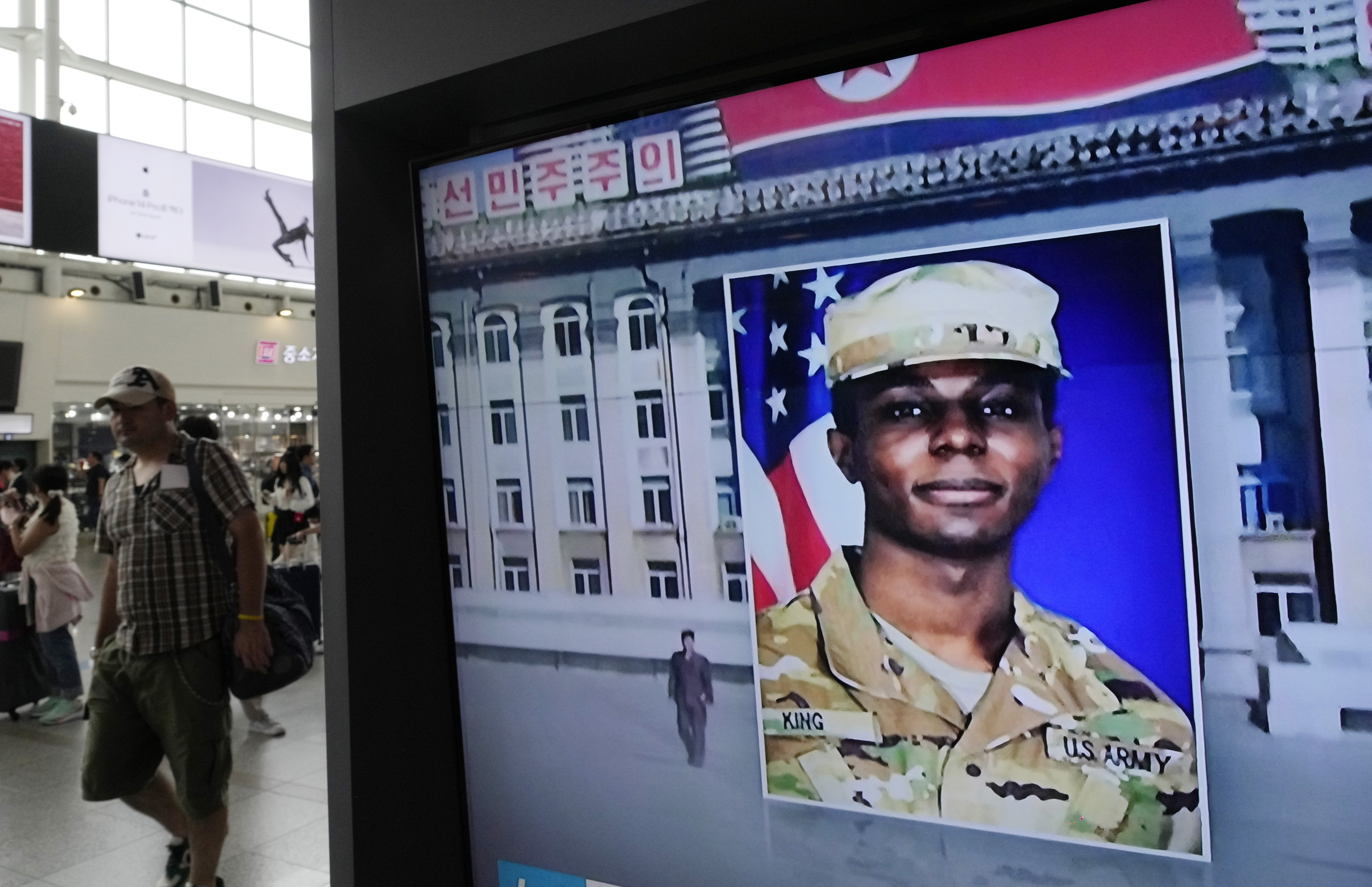 A television screen shows a file image of Pvt. Travis King during a news program at the Seoul Railway Station