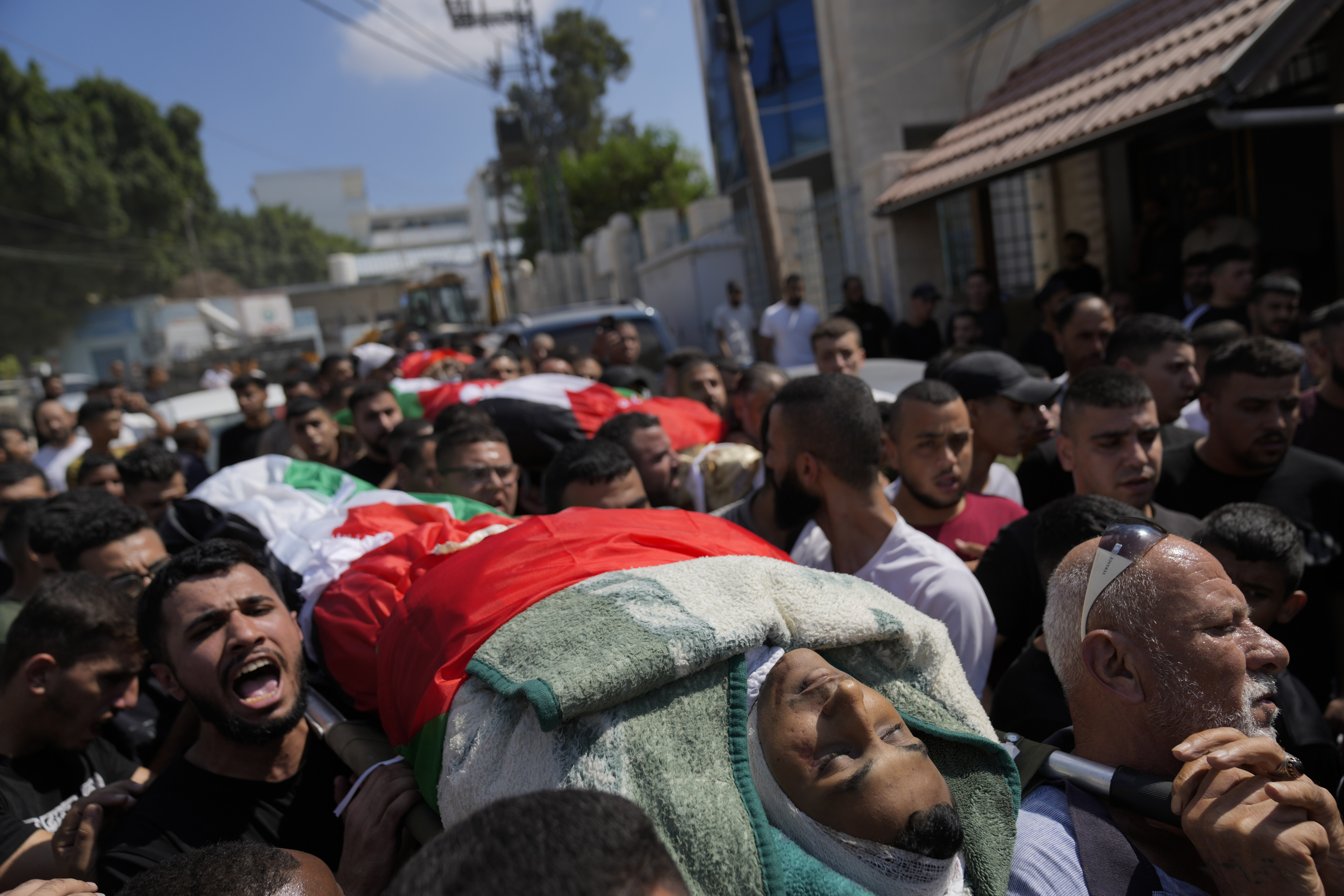 Mourners take part in a funeral of four Palestinians who died during an Israeli military operation