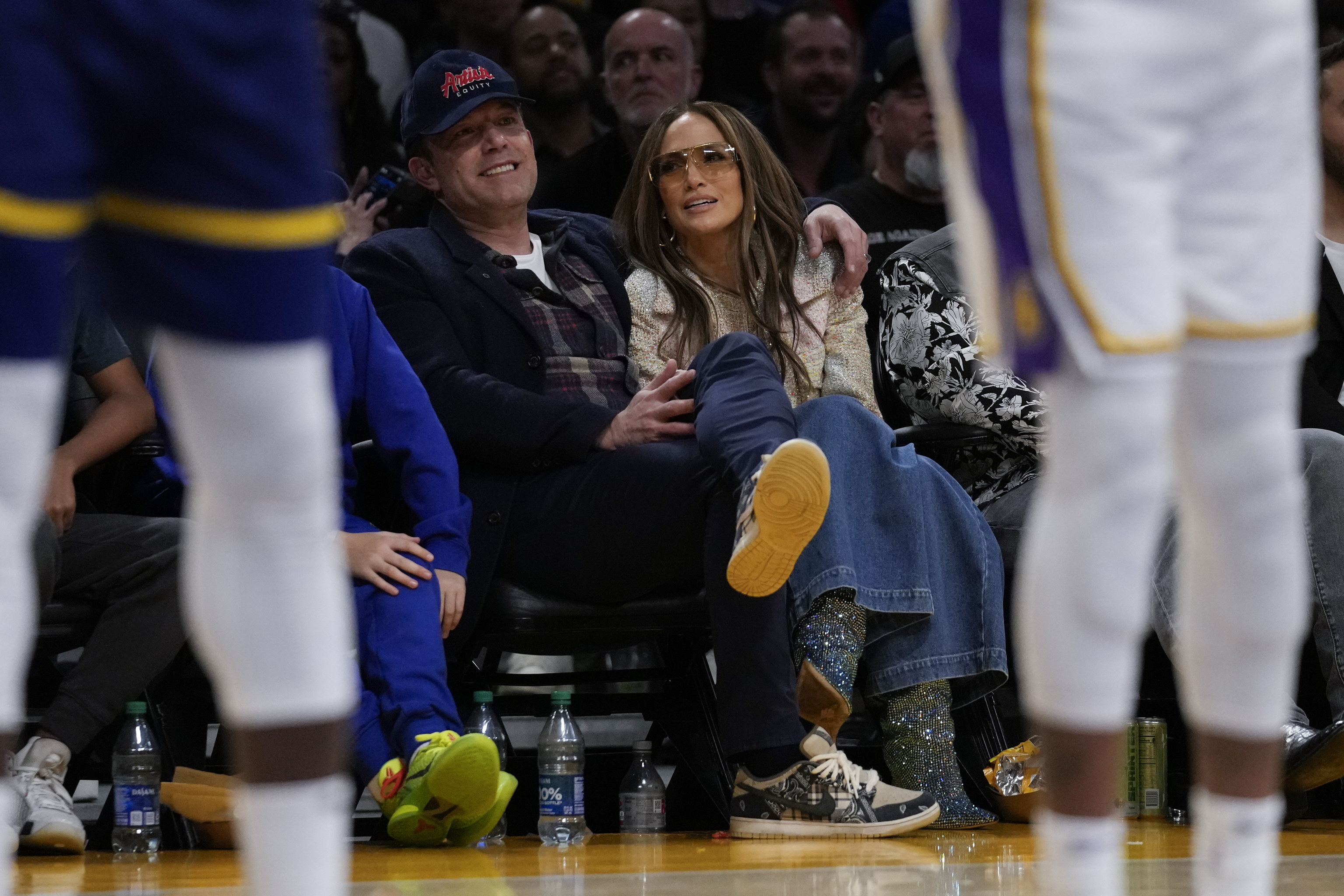 Ben Affleck and Jennifer Lopez watch an NBA basketball game