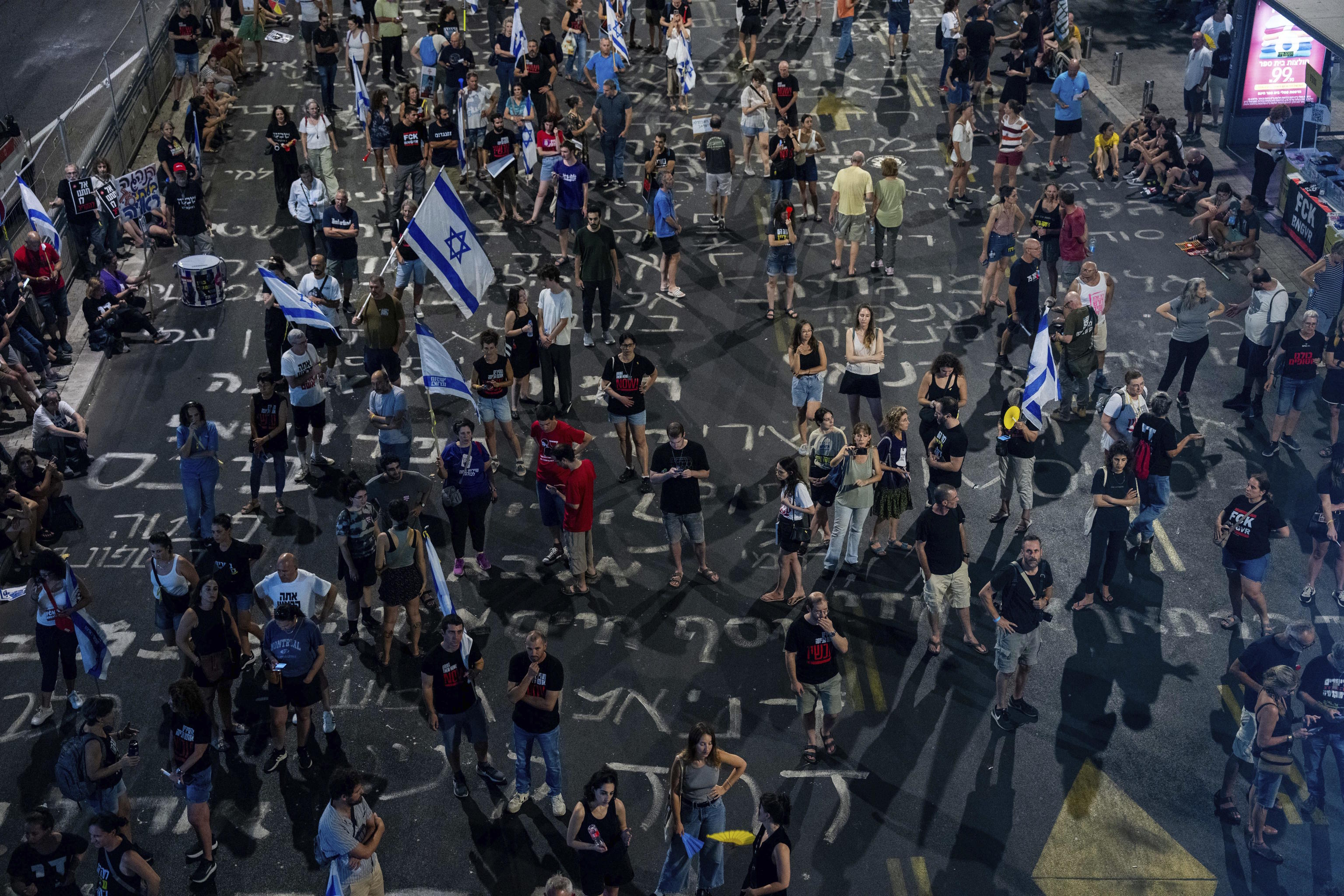 People protest against Prime Minister Netanyahu's government in Tel Aviv.