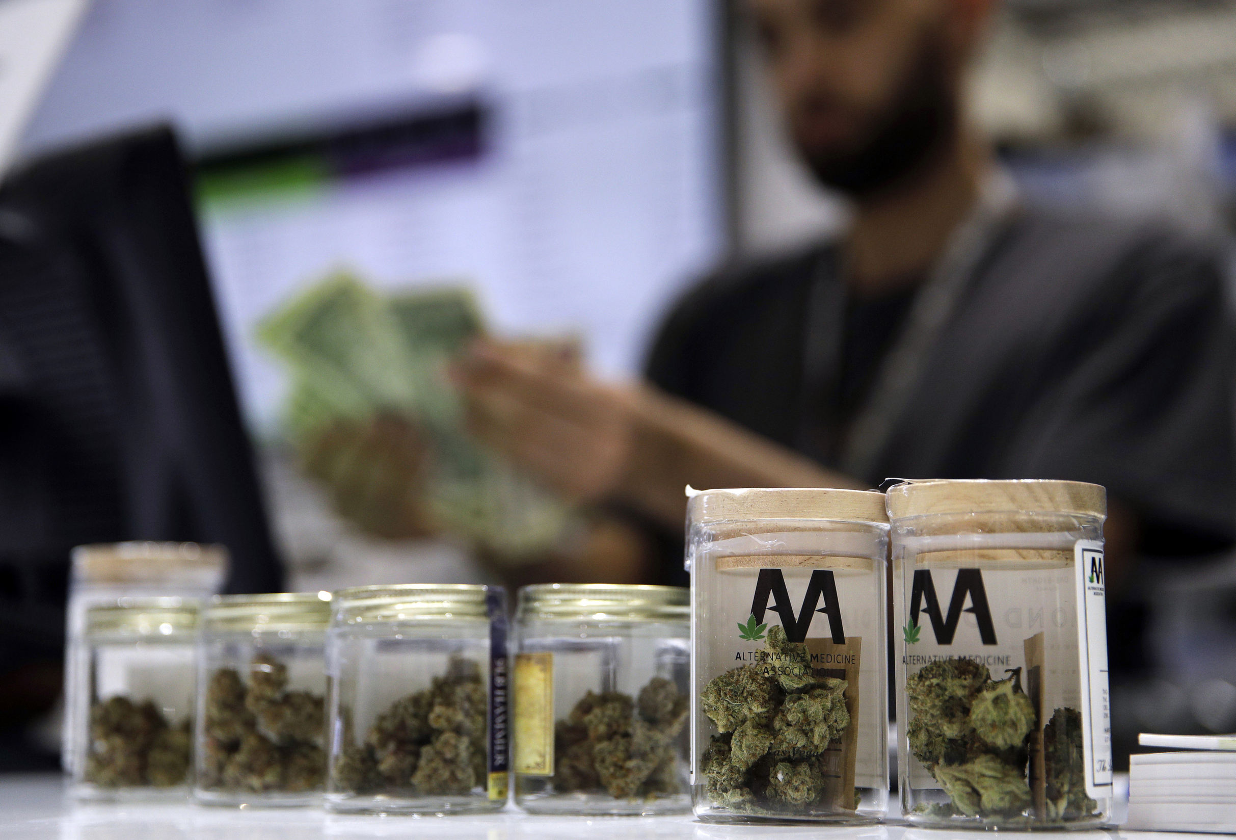 A cashier rings up a marijuana sale