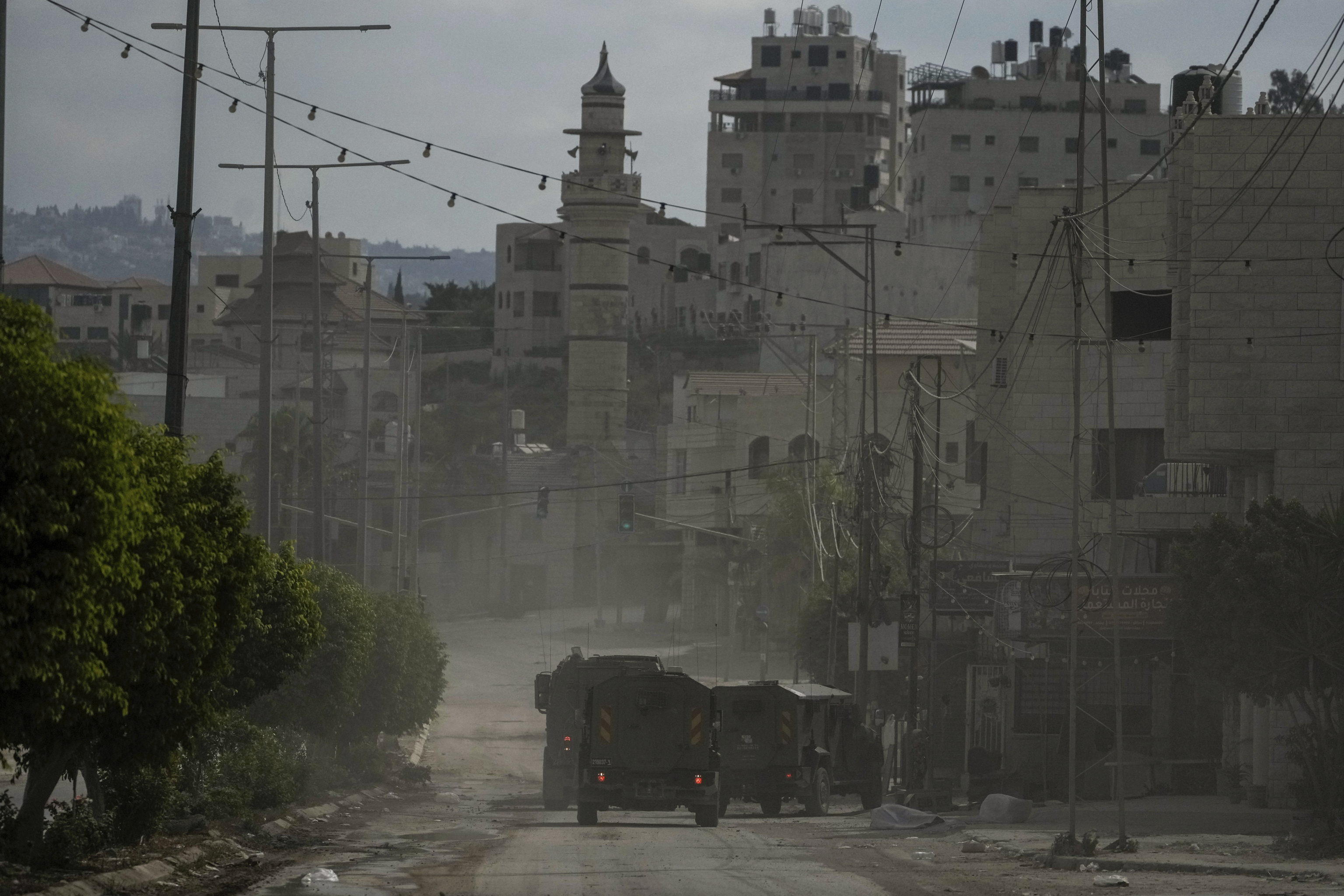 A convoy of Israeli military armored vehicles is seen during an army raid in Tulkarem