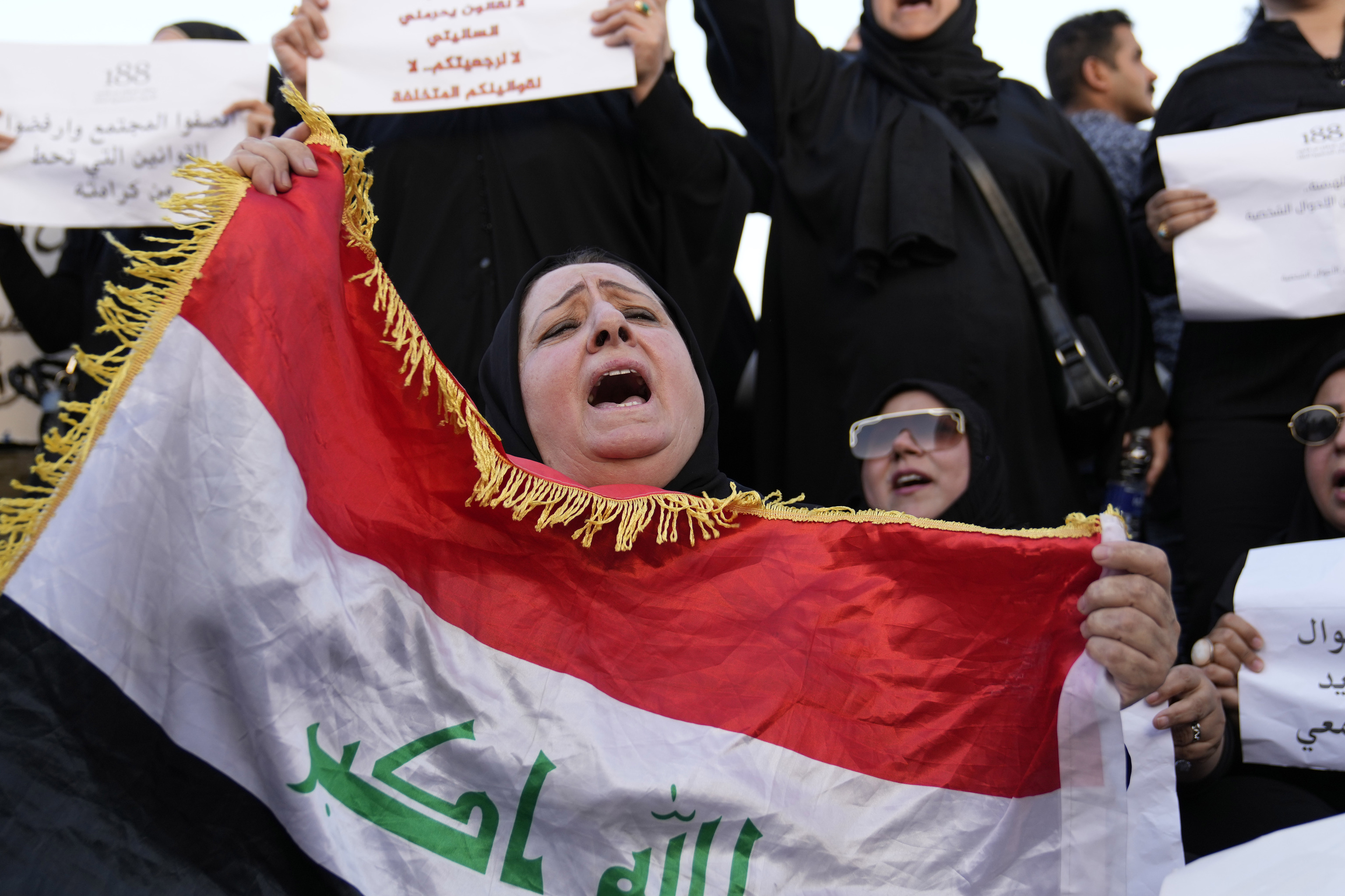 Protesters gather to demonstrate against a proposed law to permit underage female marriage in Tahrir Square in Baghdad