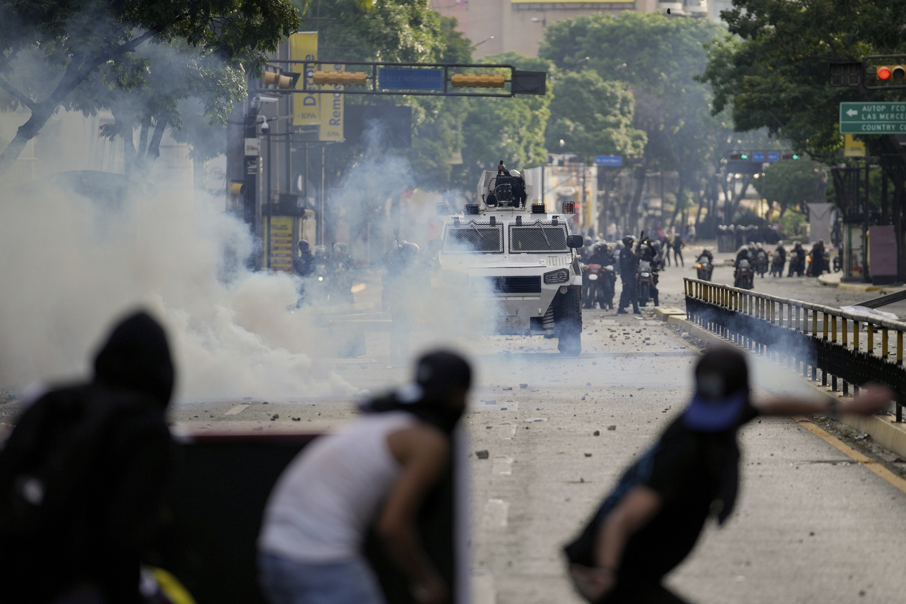 Protesters clash with police during demonstrations against the official election results declaring President Nicolas Maduro's reelection