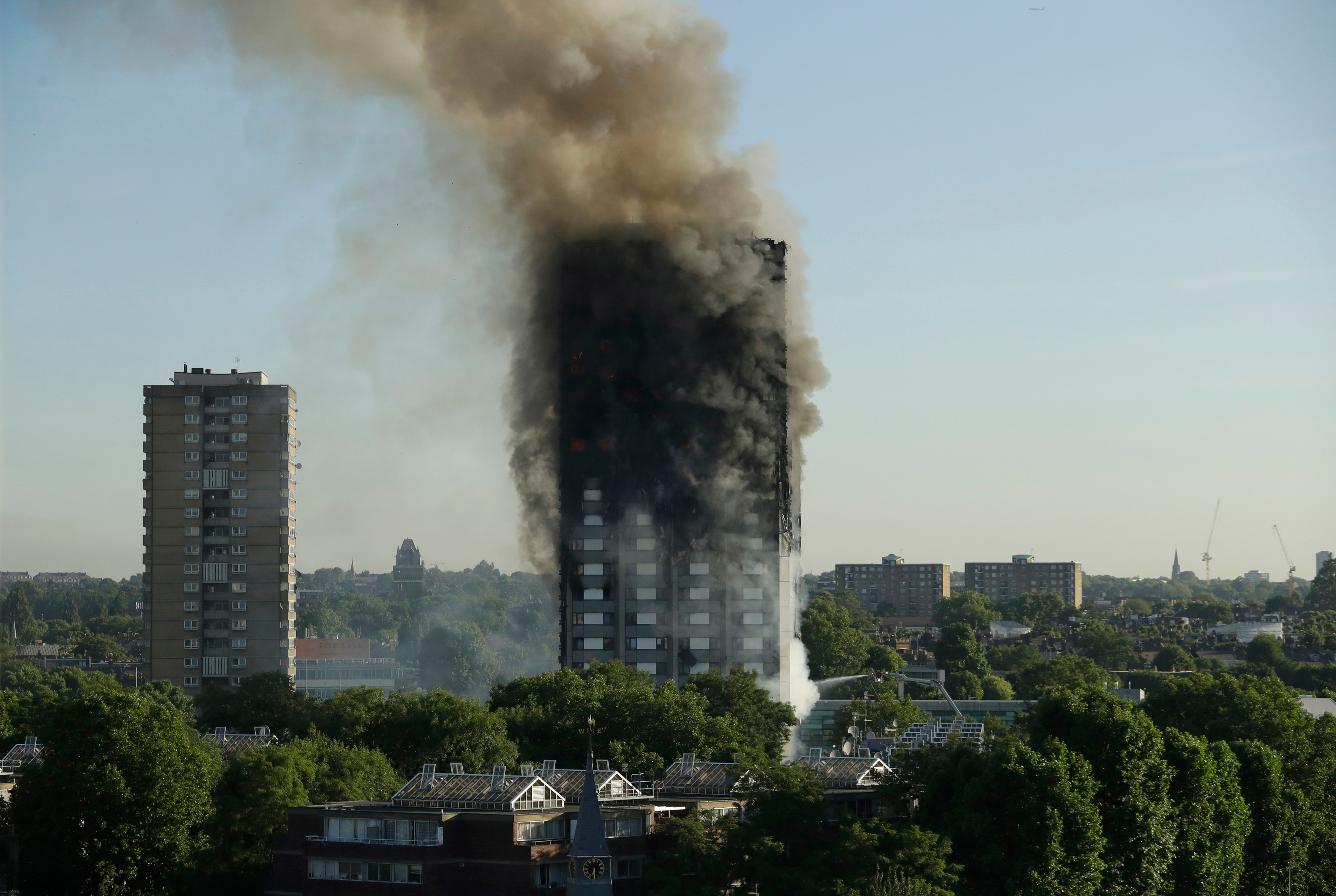 smoke rises from Grenfell Tower in London.