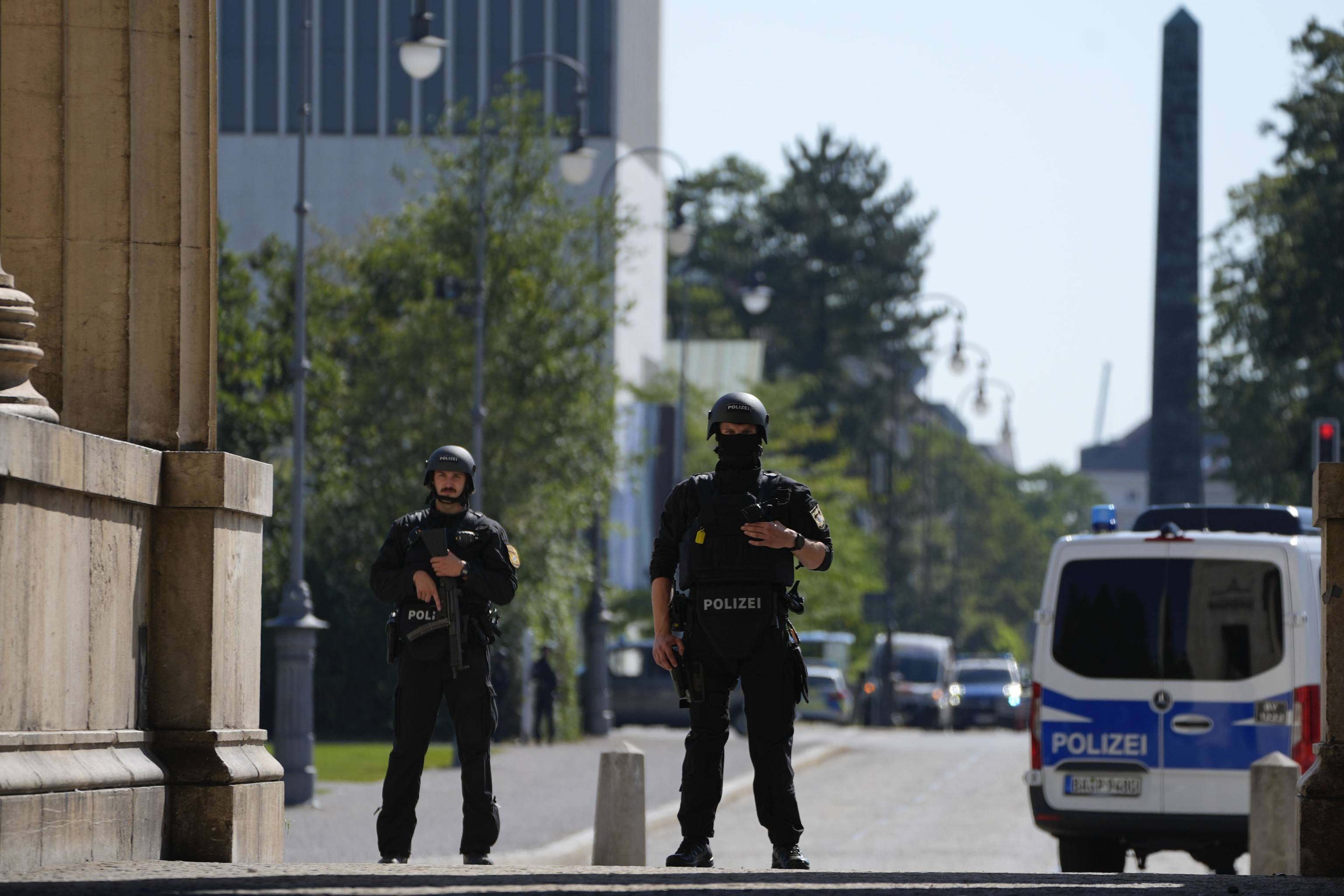 Police officers stand guard after police fired shots at a suspicious person near the Israeli Consulate.