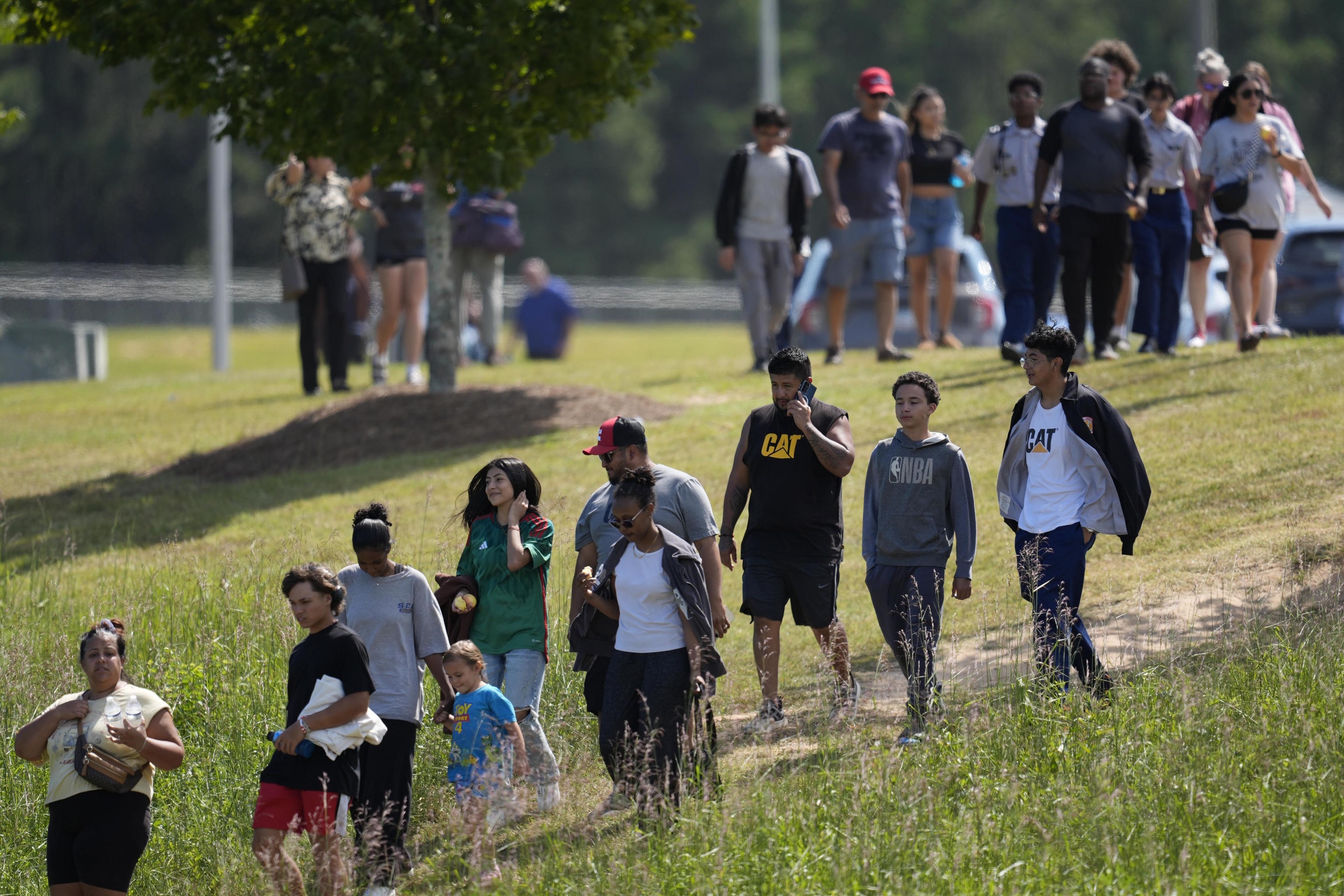 Students and parents walk off campus at Apalachee High School.