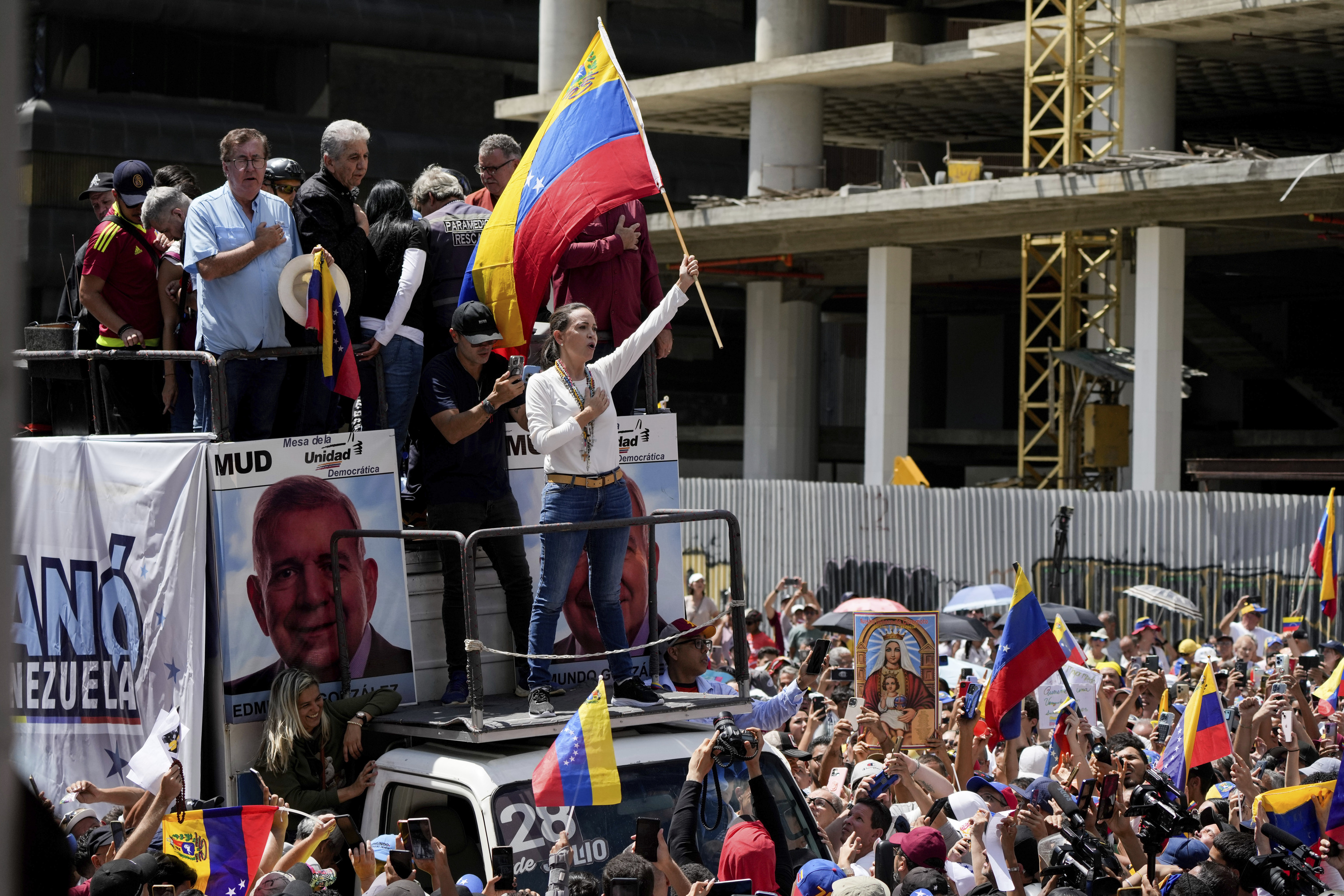 Opposition leader Maria Corina Machado rides on the top of a truck