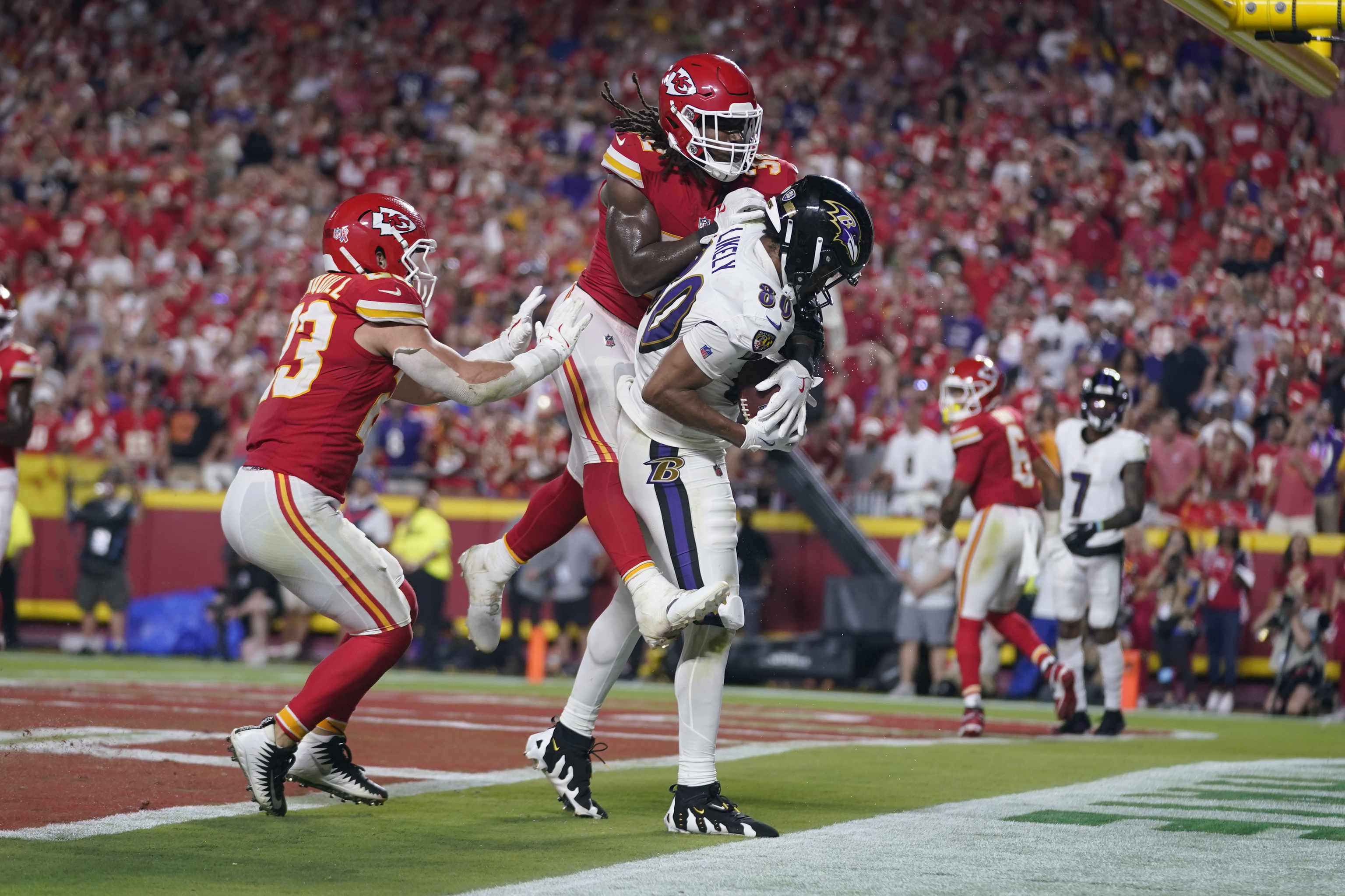 Baltimore Ravens tight end Isaiah Likely (80) catches a pass with his toe out of bounds as Kansas City Chiefs linebacker Nick Bolton and linebacker Drue Tranquill