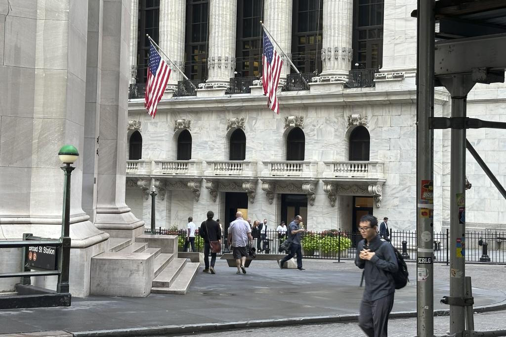 People pass the New York Stock Exchange.