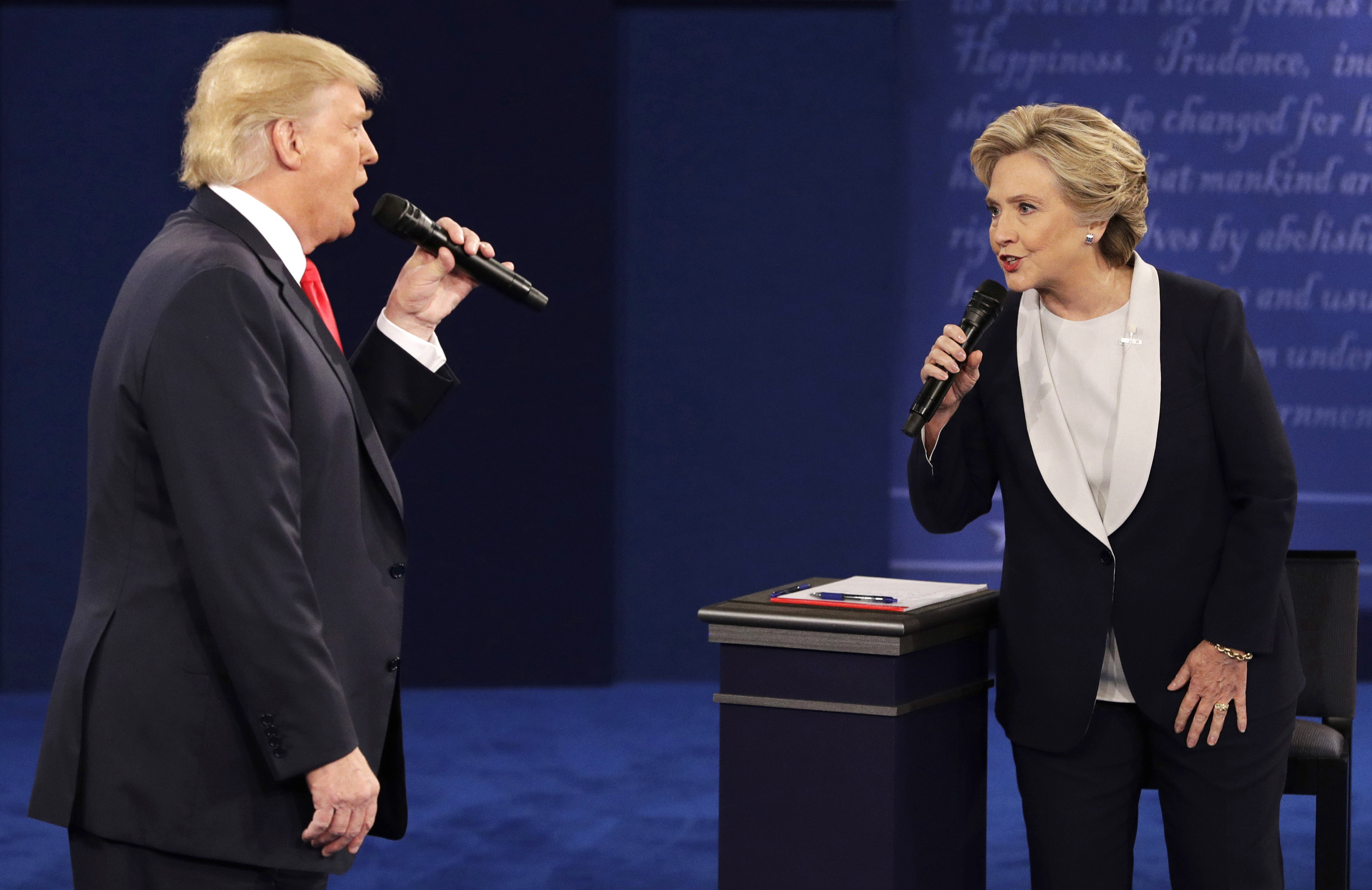 Republican presidential nominee Donald Trump, left, and Democratic presidential nominee Hillary Clinton speak during the second presidential debate i