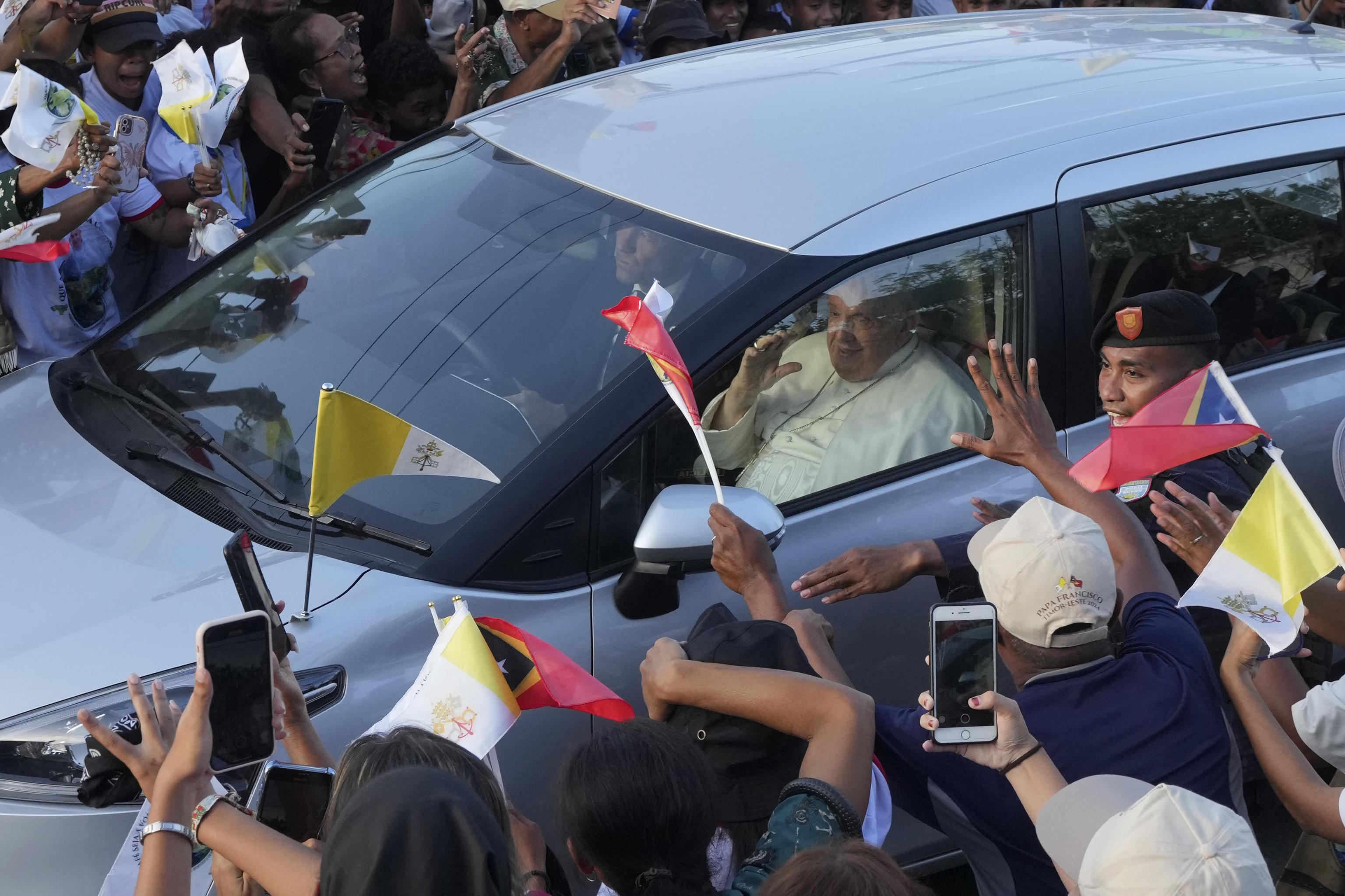 People greet Pope Francis on way to the Presidential Palace in East Timor.