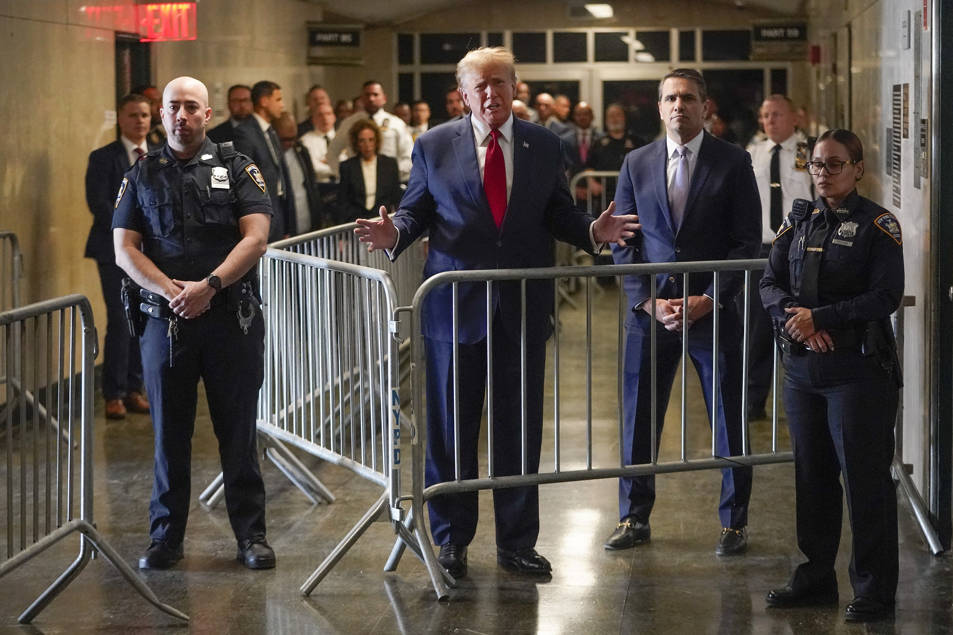 Former President Donald Trump speaks before entering the courtroom at Manhattan criminal court