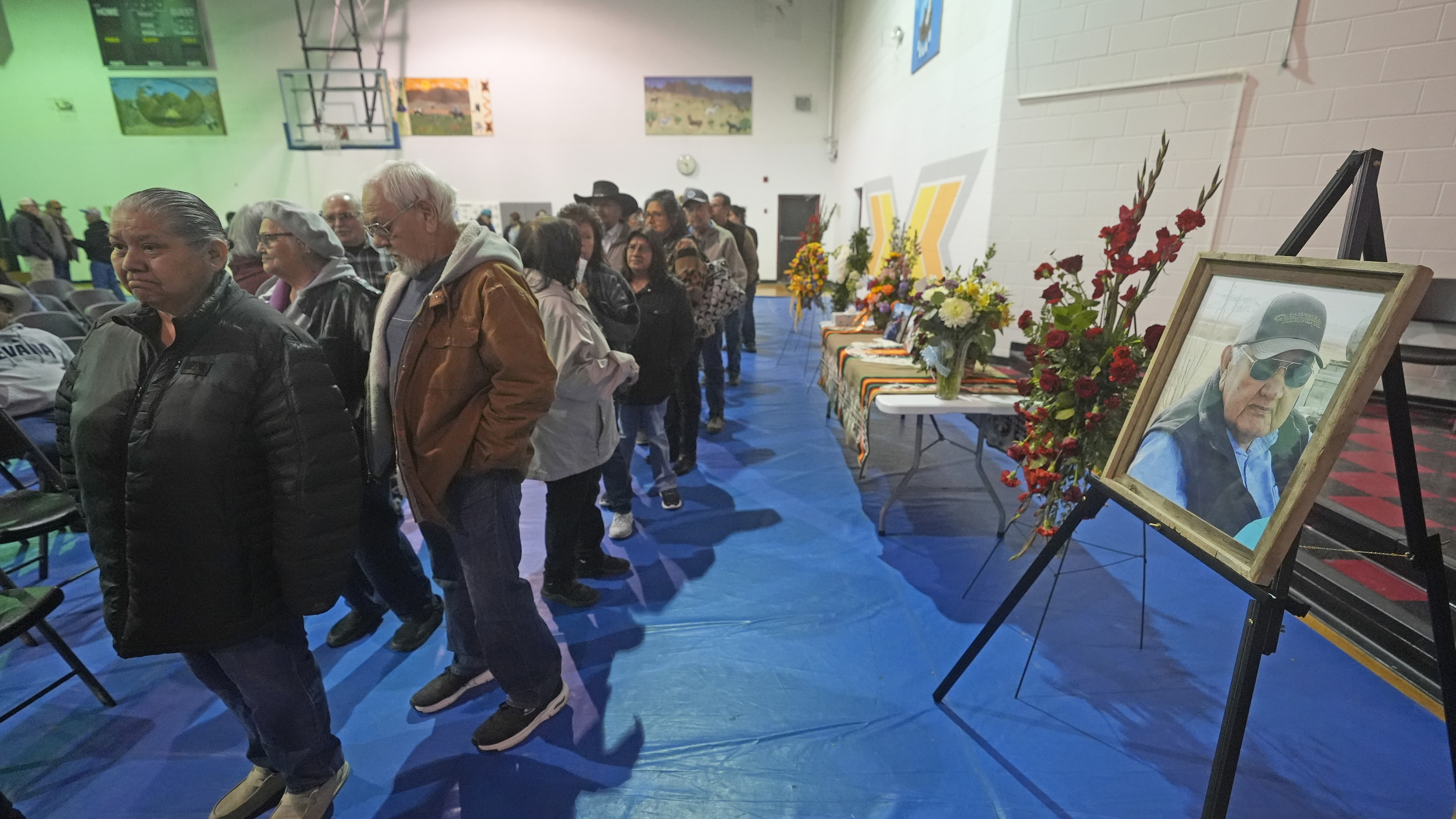 Tribal members gather in a gymnasium to pay their respects to Marvin Cota, who died from cancer, during a memorial service in Owyhee