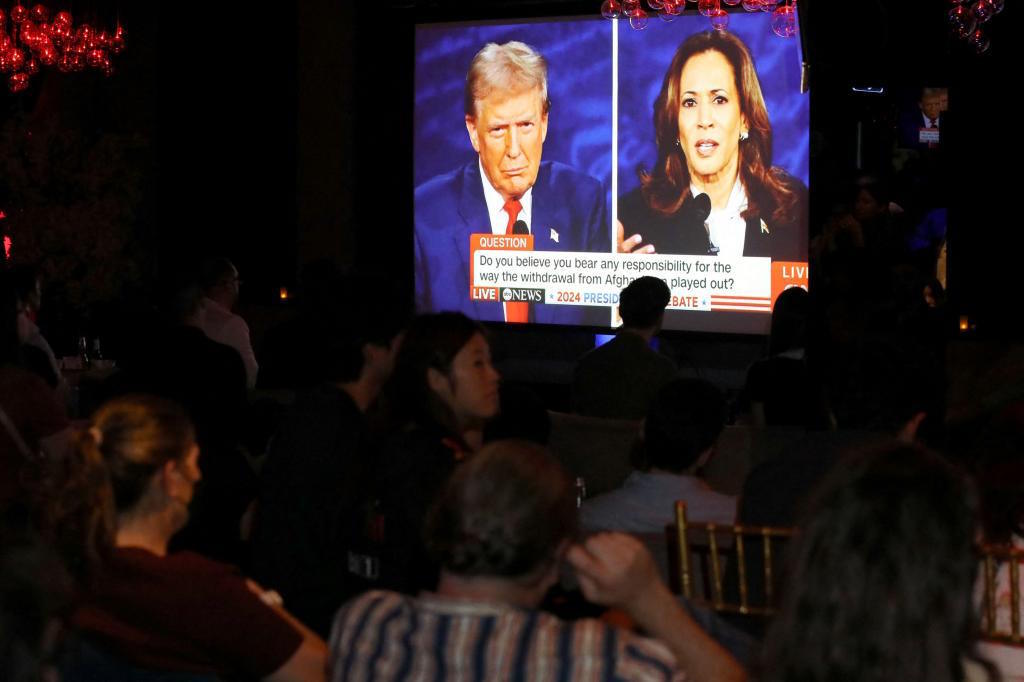 People attend a watch party for the US Presidential debate.