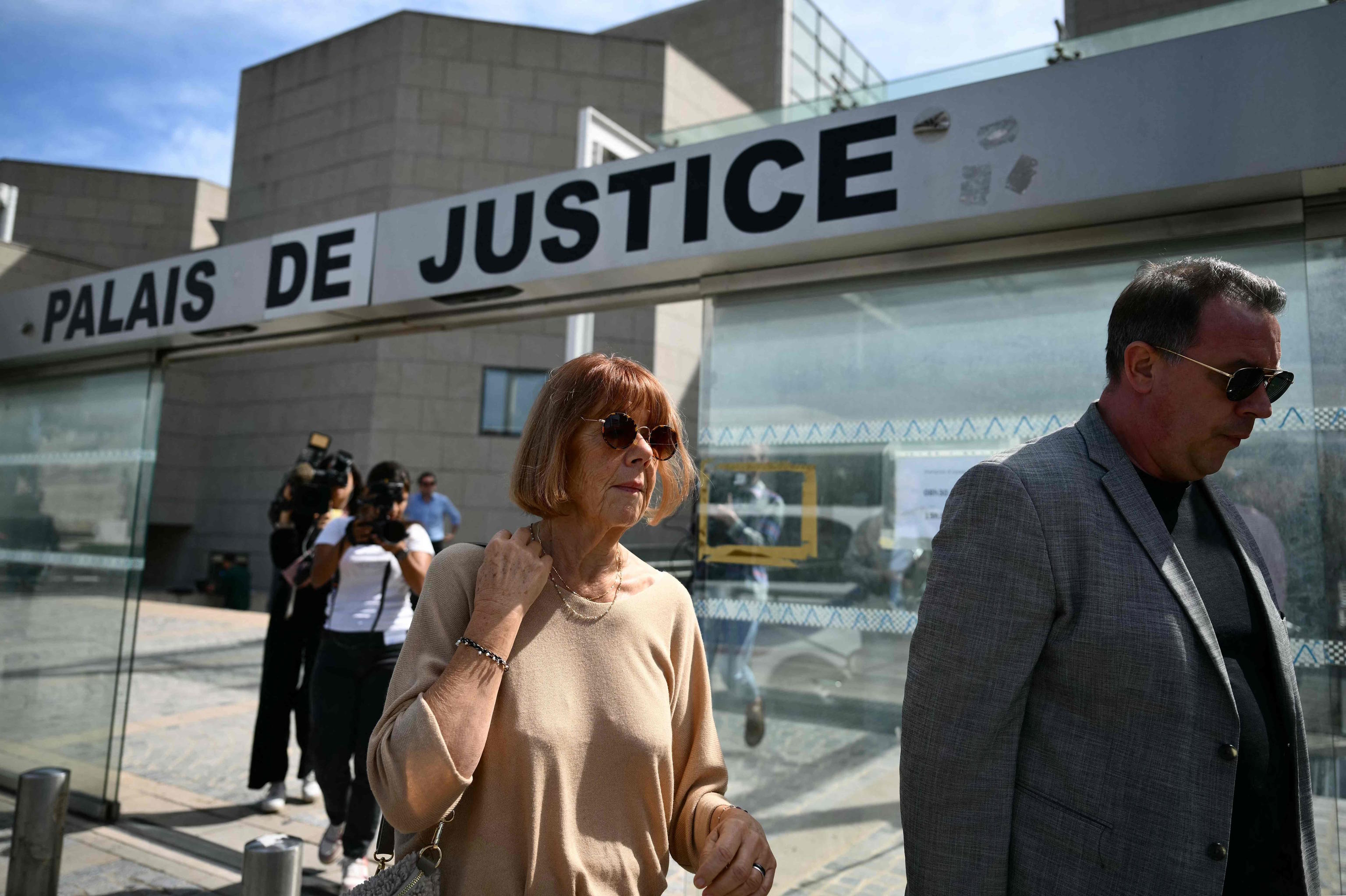 Gisele Pelicot (C), leaves the court with her son,