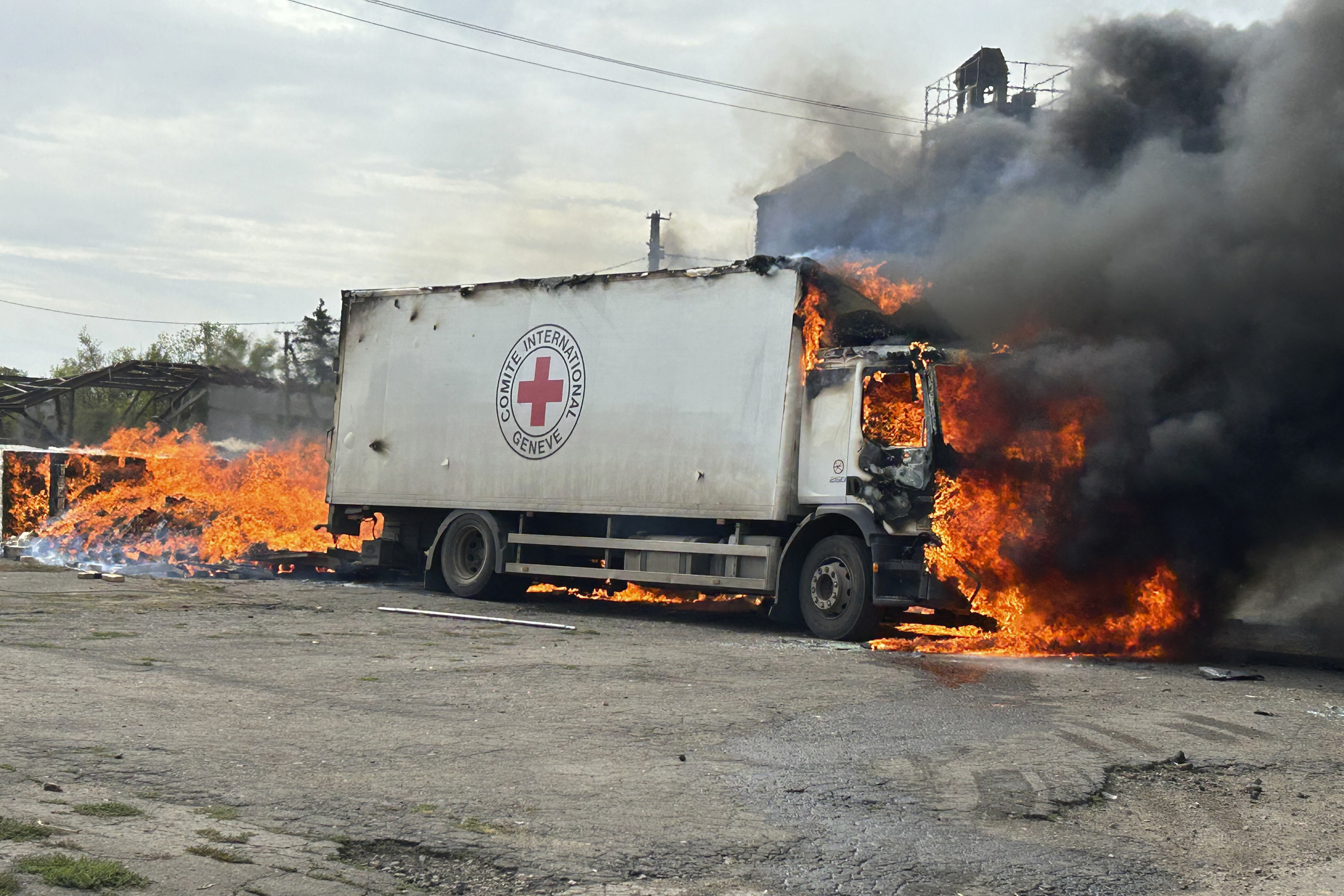 A burning Red Cross vehicle that was destroyed in a Russian strike in the Donetsk region