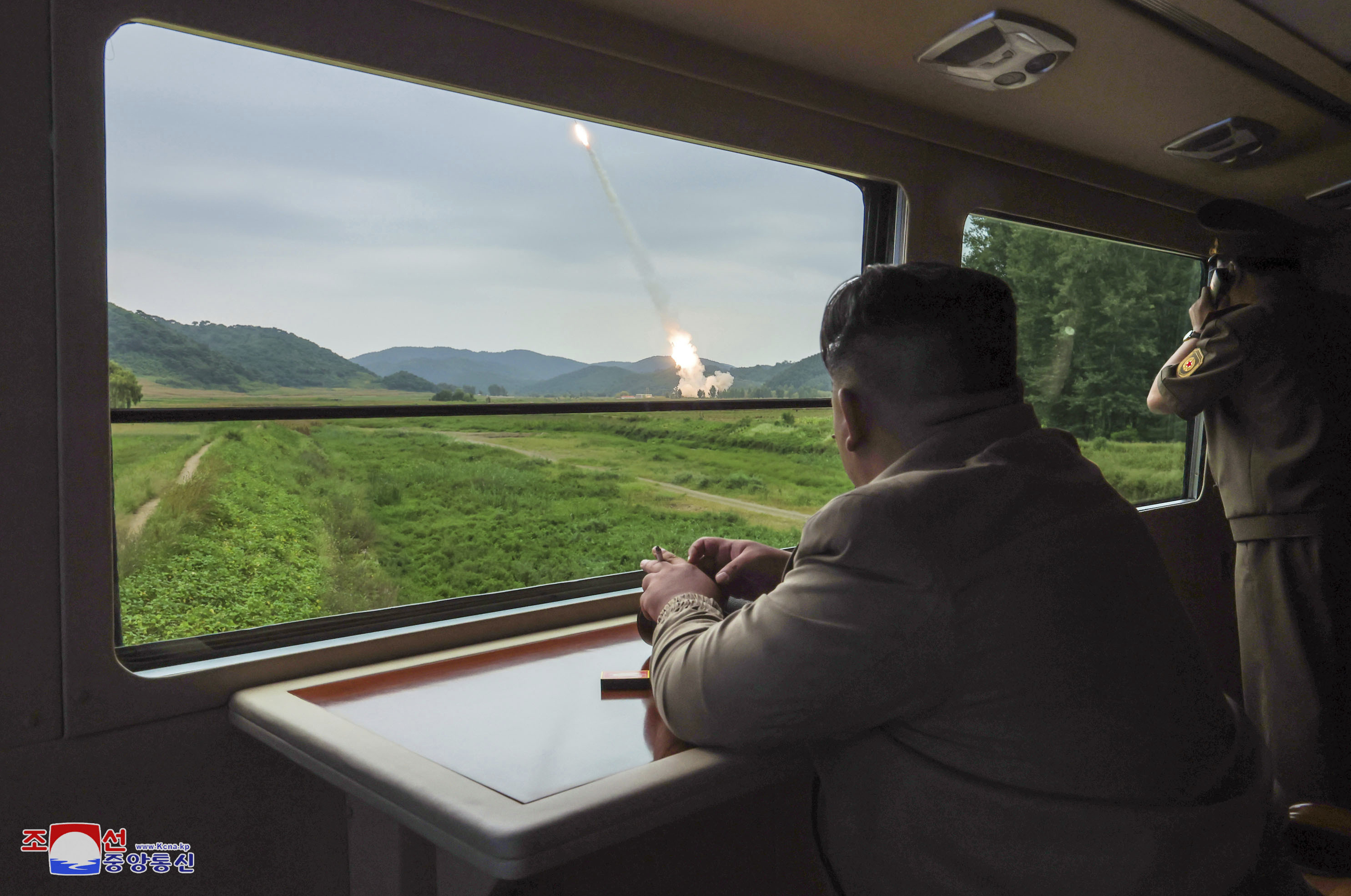 leader Kim Jong Un, center right, inspects what they say is test-firing