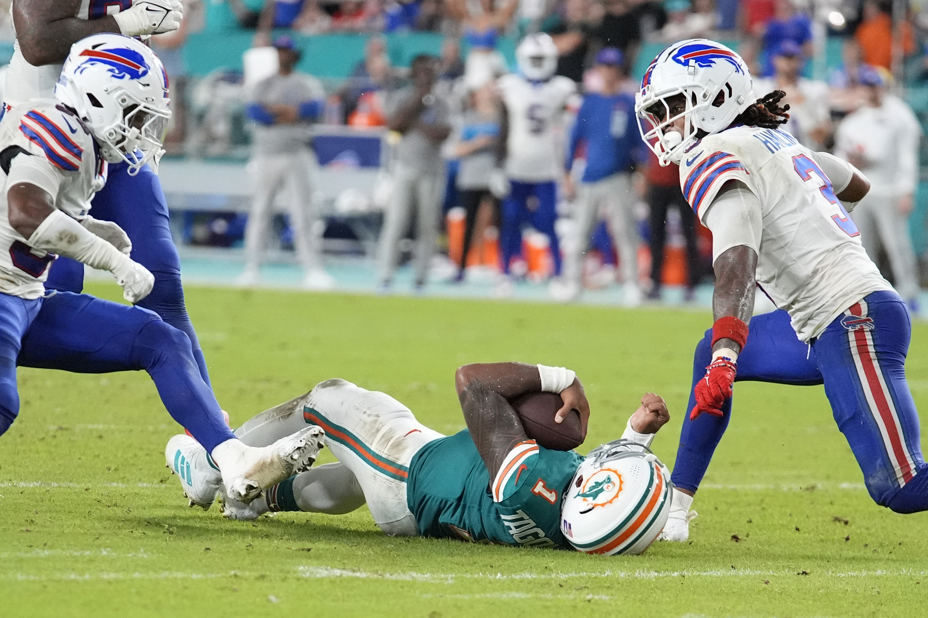 Miami Dolphins quarterback Tua Tagovailoa (1) falls in the field after colliding with Buffalo Bills safety Damar Hamlin (3).