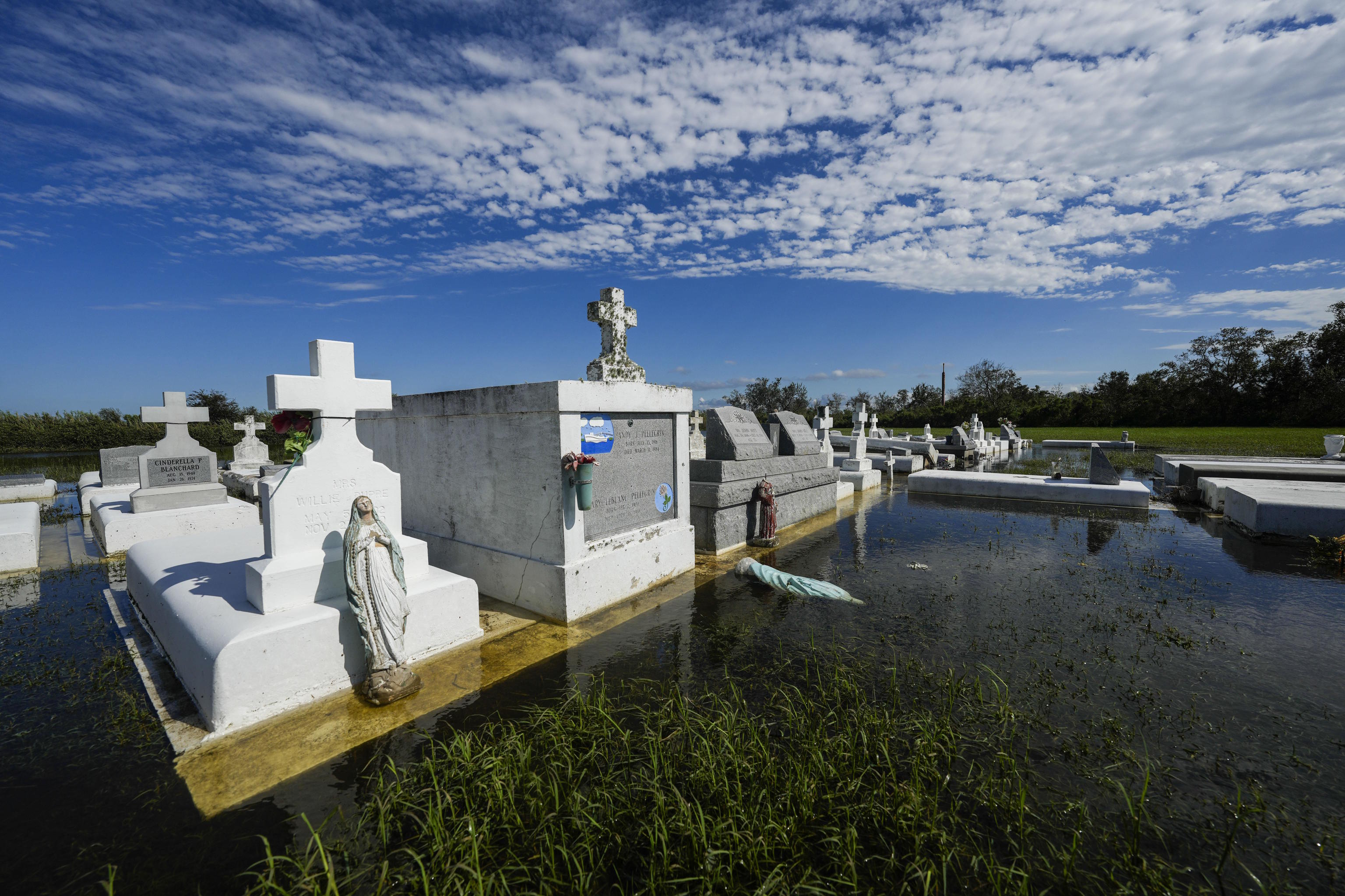 Tombs are seen after being disturbed by flooding Hurricane Francine.