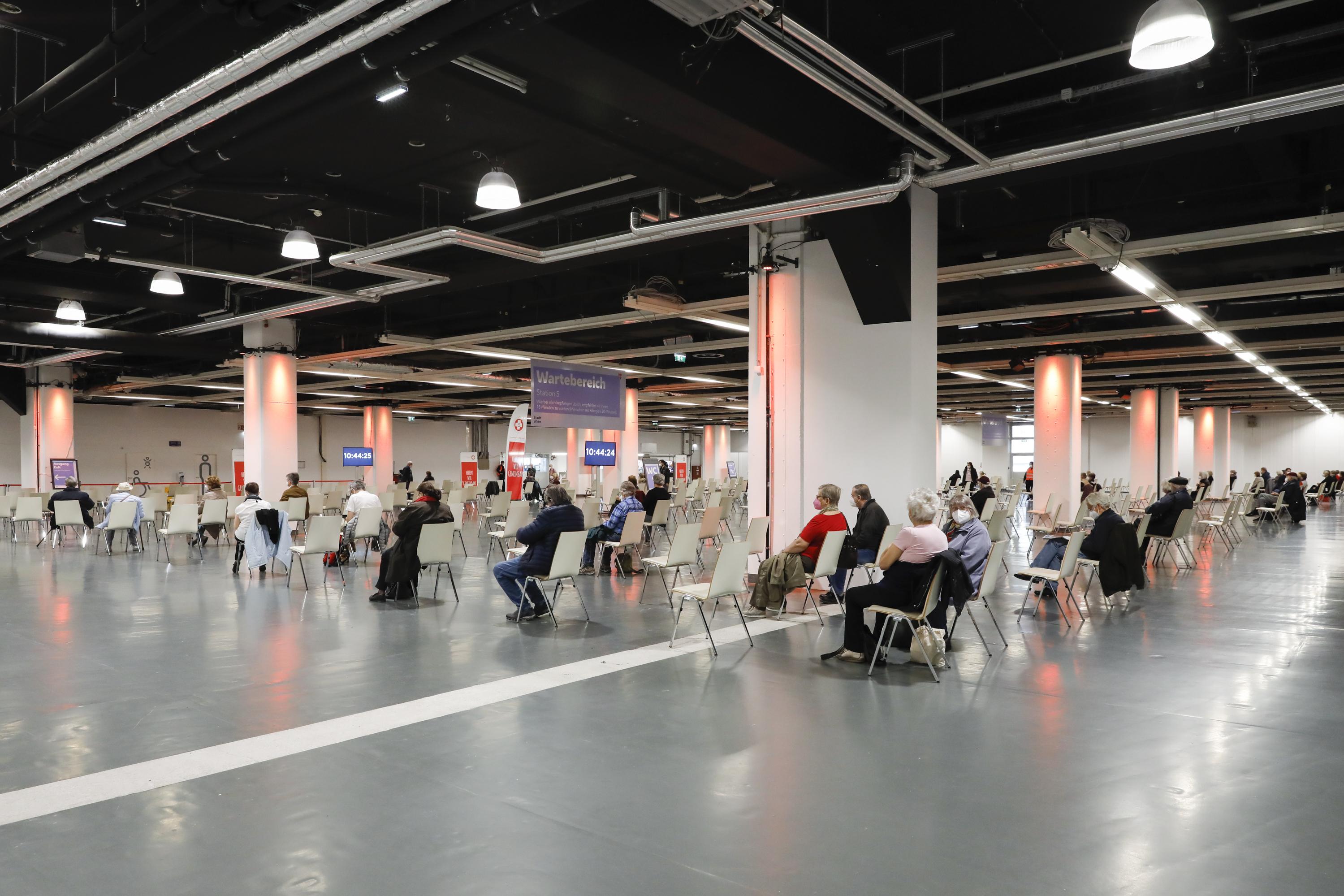 People rest after receiving the vaccination against the new coronavirus in the 'Austria Center Vienna' in Vienna