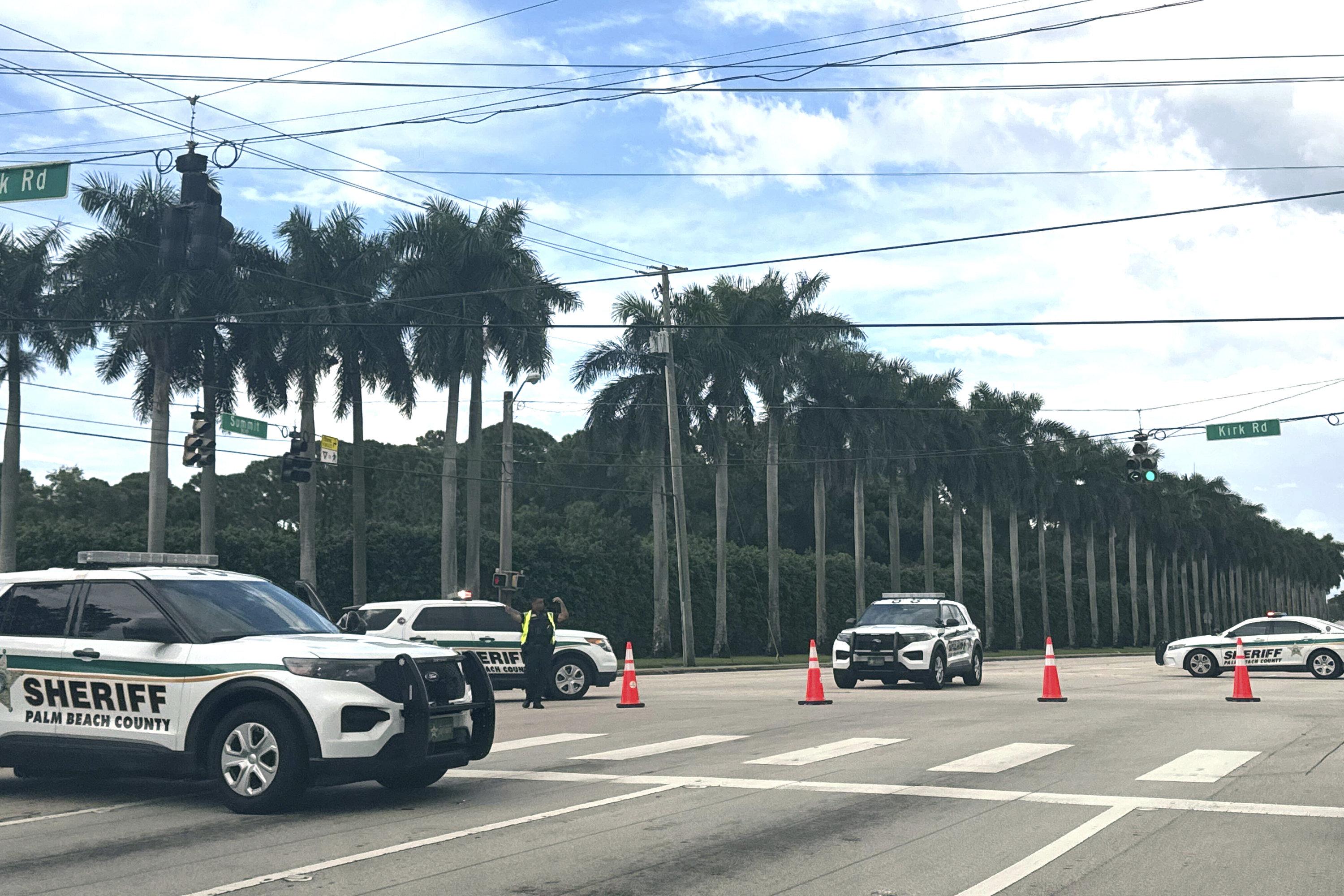 Sheriff vehicles are pictured near Trump International Golf Club