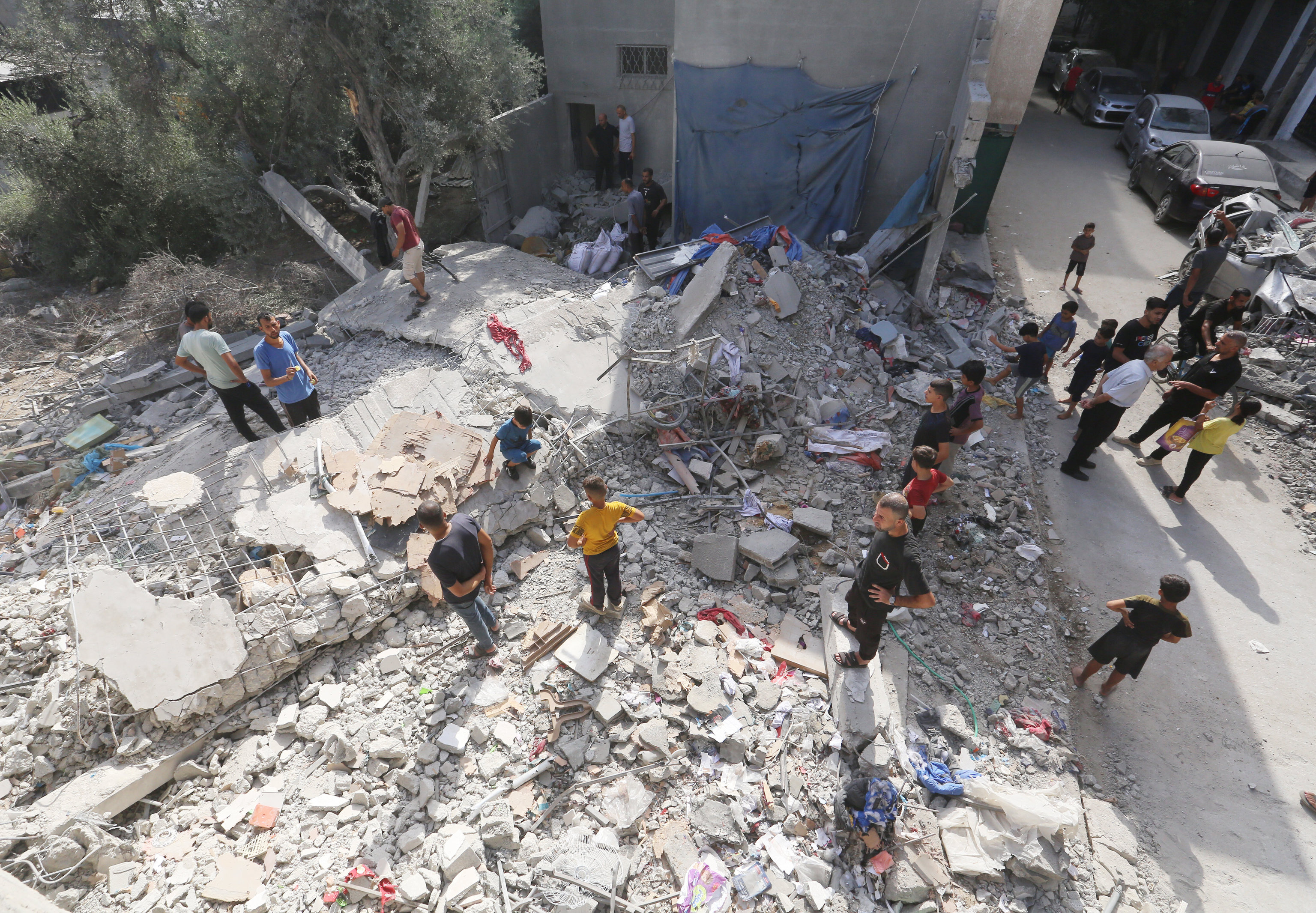 Palestinians check the area following Israeli strikes in Nuseirat