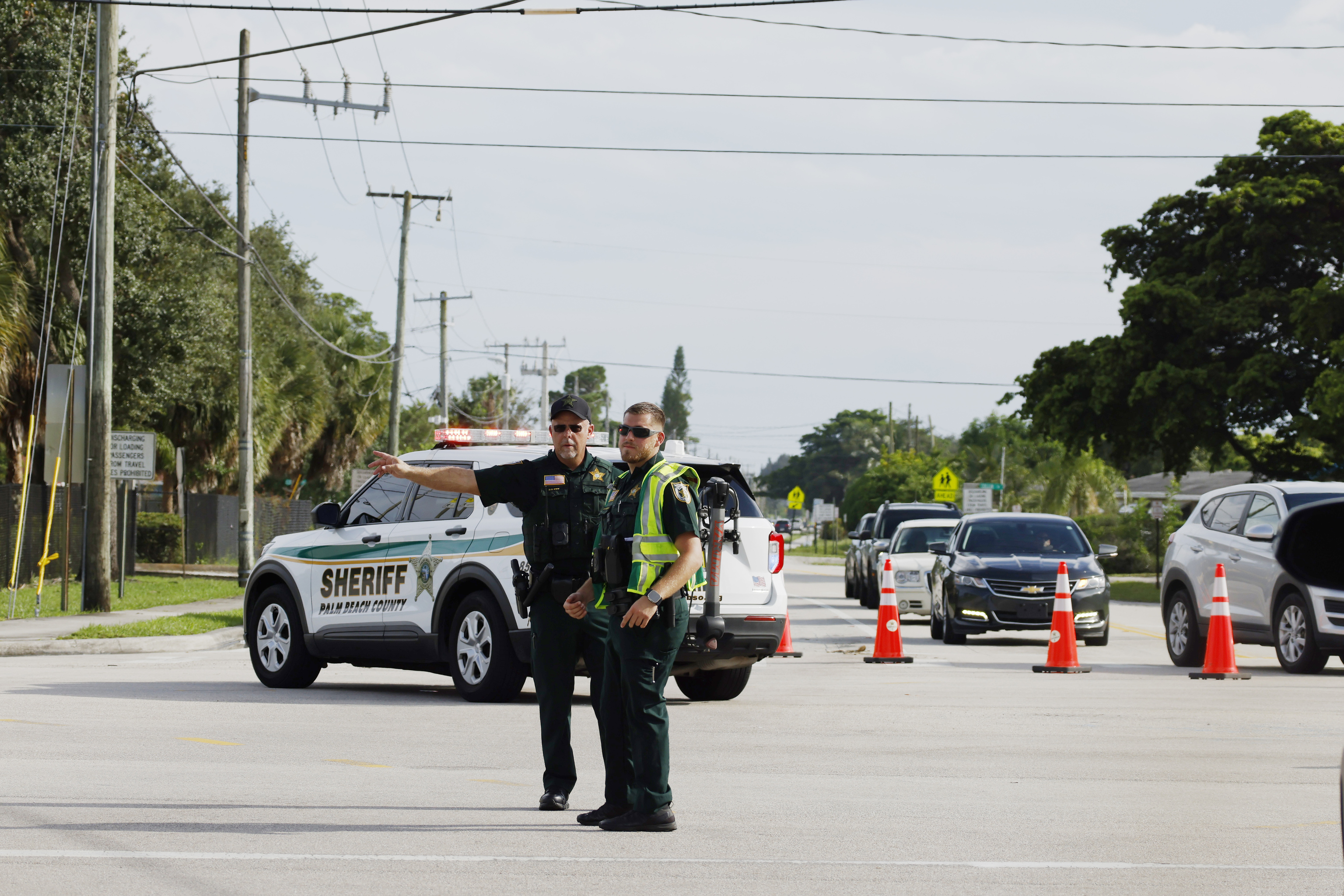 Police officers direct traffic near Trump International Golf Club after the apparent assassination attempt of Republican presidential nominee former President Donald Trump