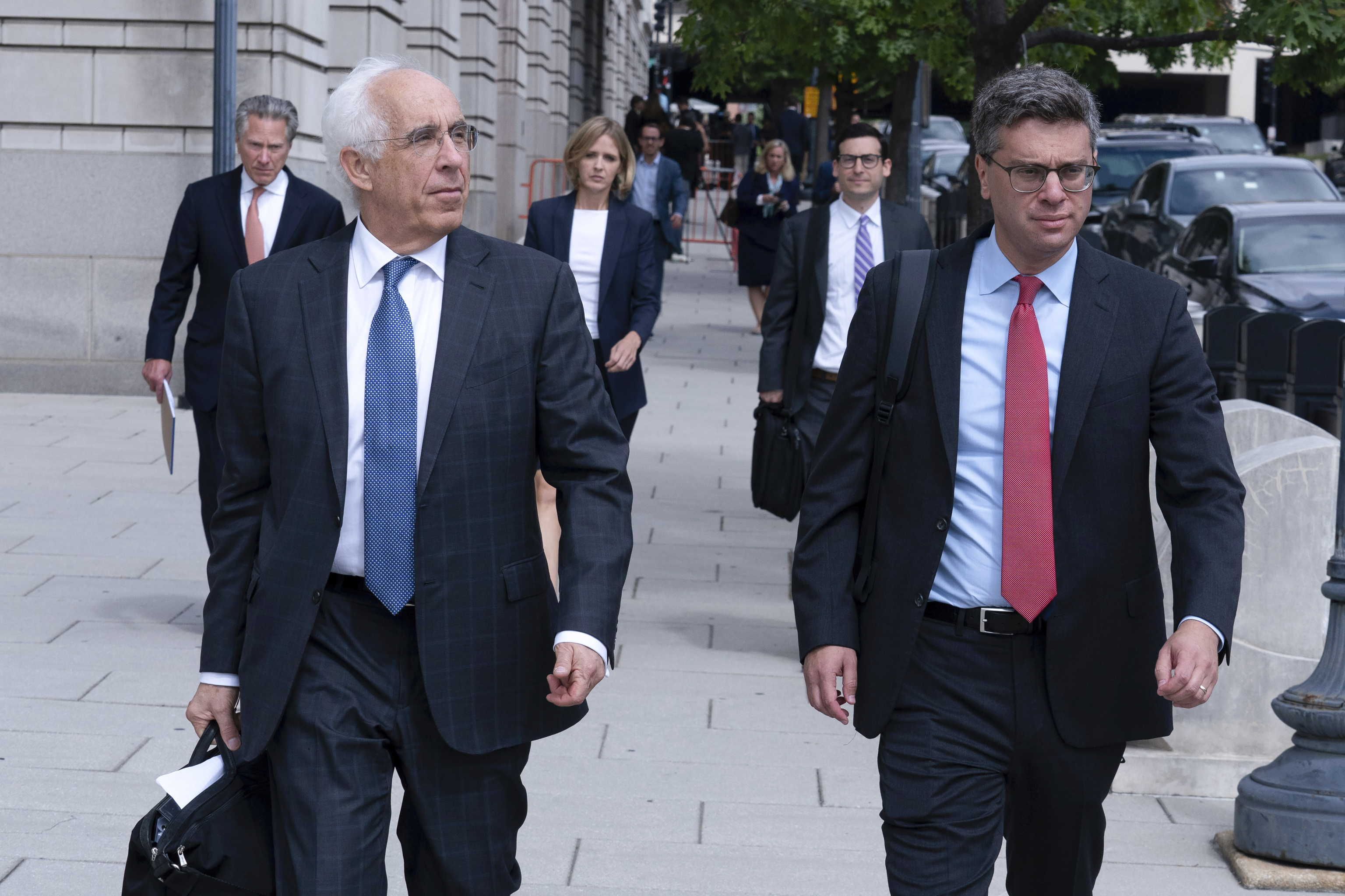 TikTok Attorneys Andrew Pincus, left, and Alexander Berengaut, right, and their team, leave the federal courthouse.