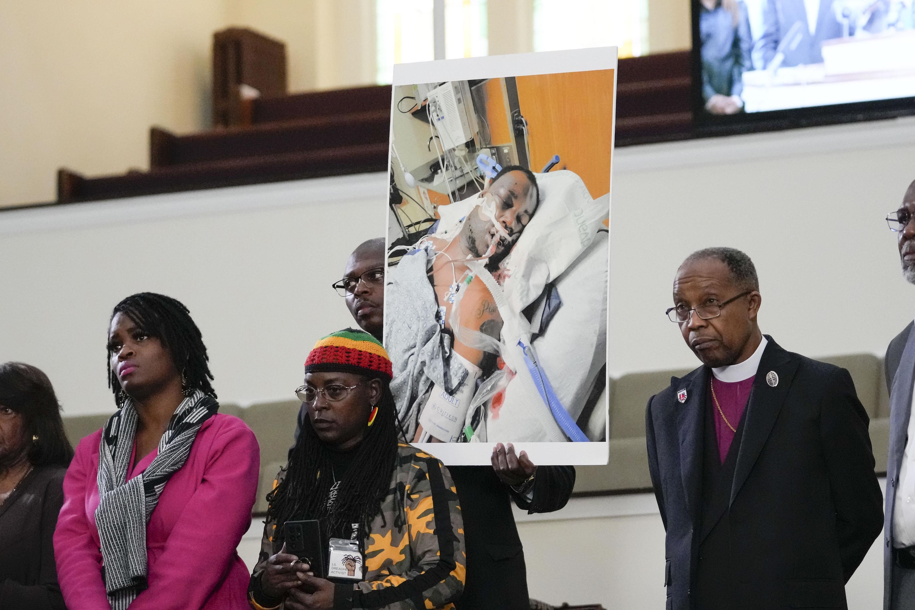 Family members and supporters hold a photograph of Tyre Nichols.