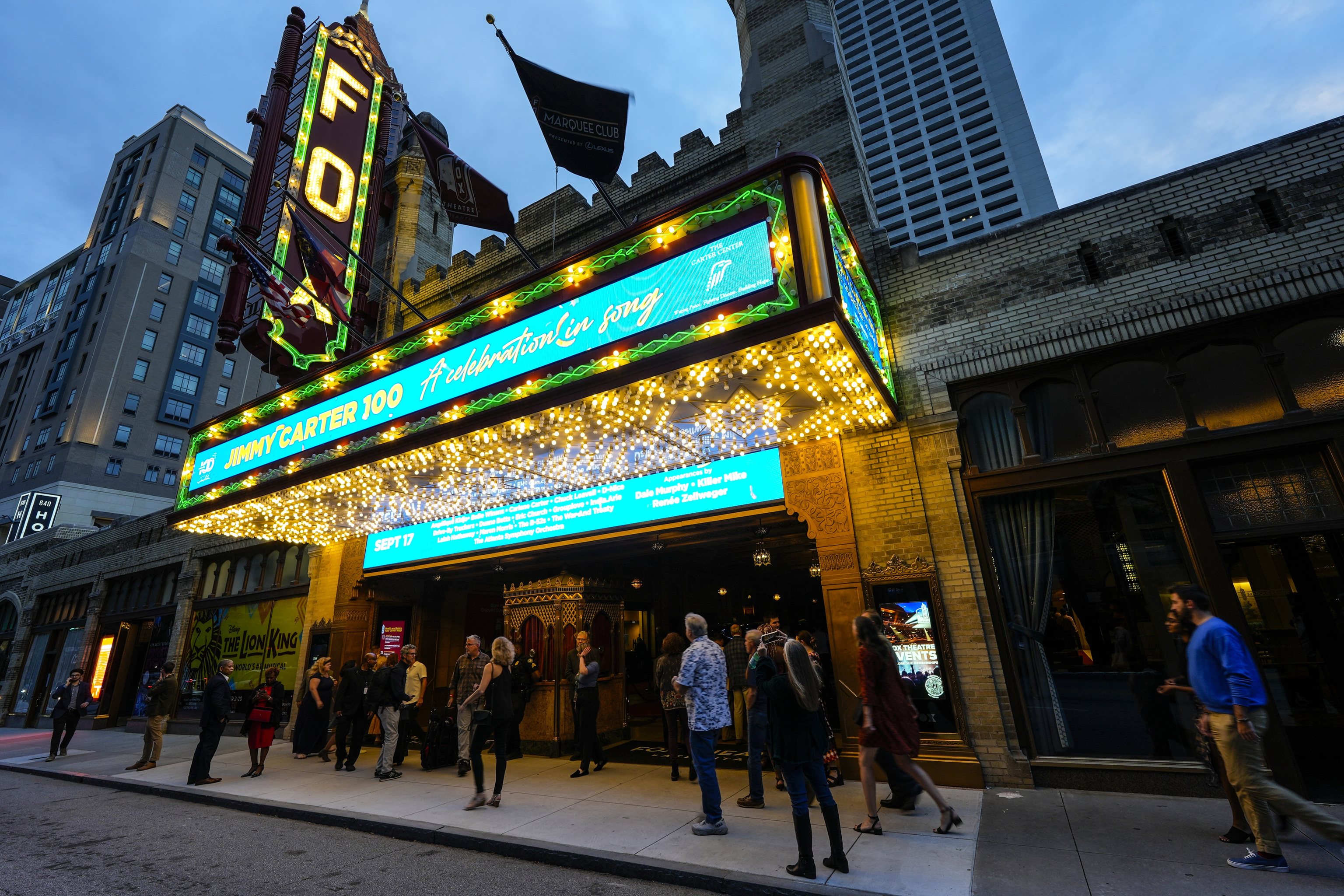 People wait in line ahead of a "Jimmy Carter 100: A Celebration in Song," concert at the Fox Theatre