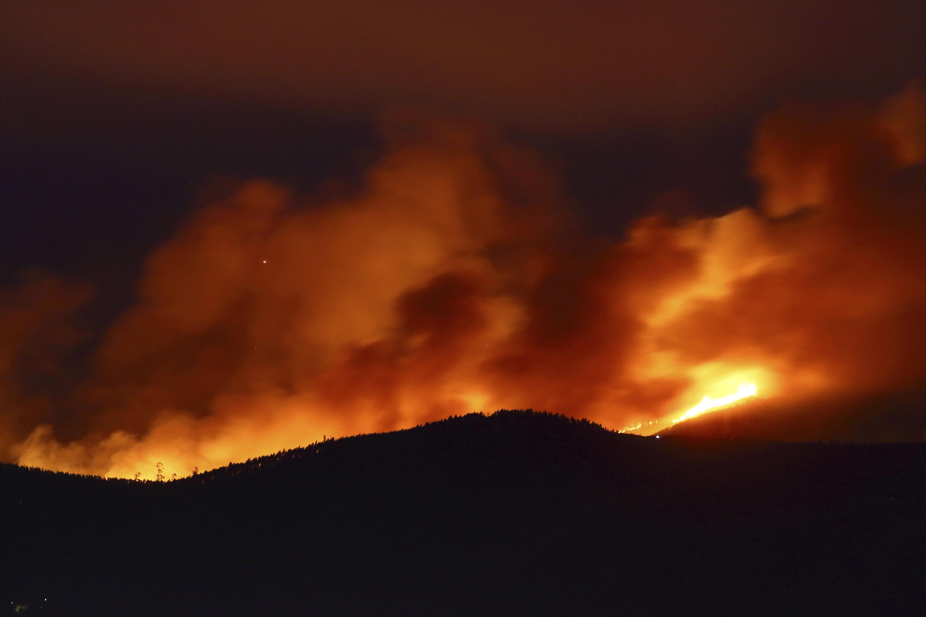 Clouds of smoke drift with the strong wind as fires rage on the hills around Sever do Vouga, a town in northern Portugal