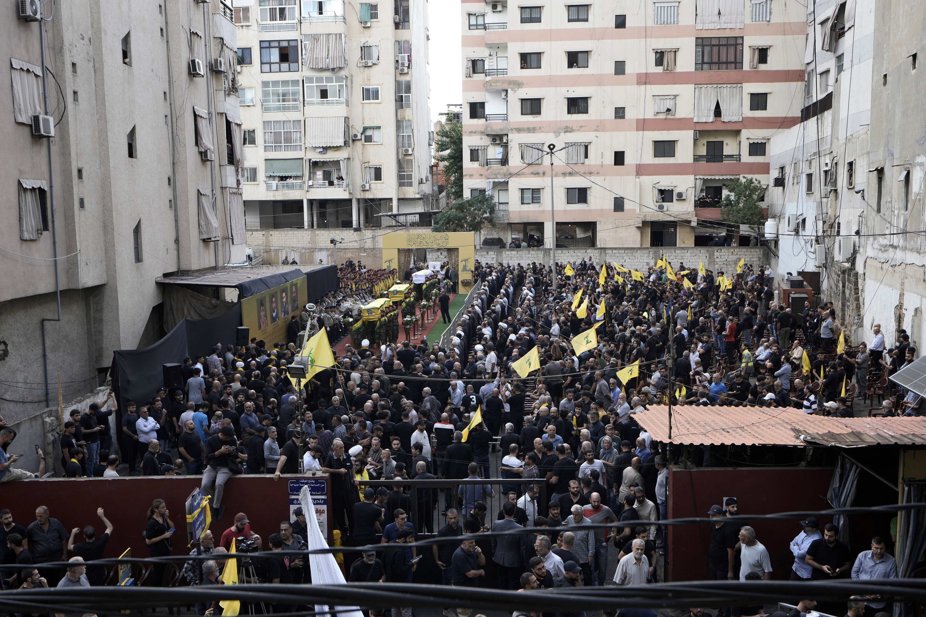 Hezbollah fighters carry the coffin of four slain comrades who were killed Tuesday after their handheld pagers exploded