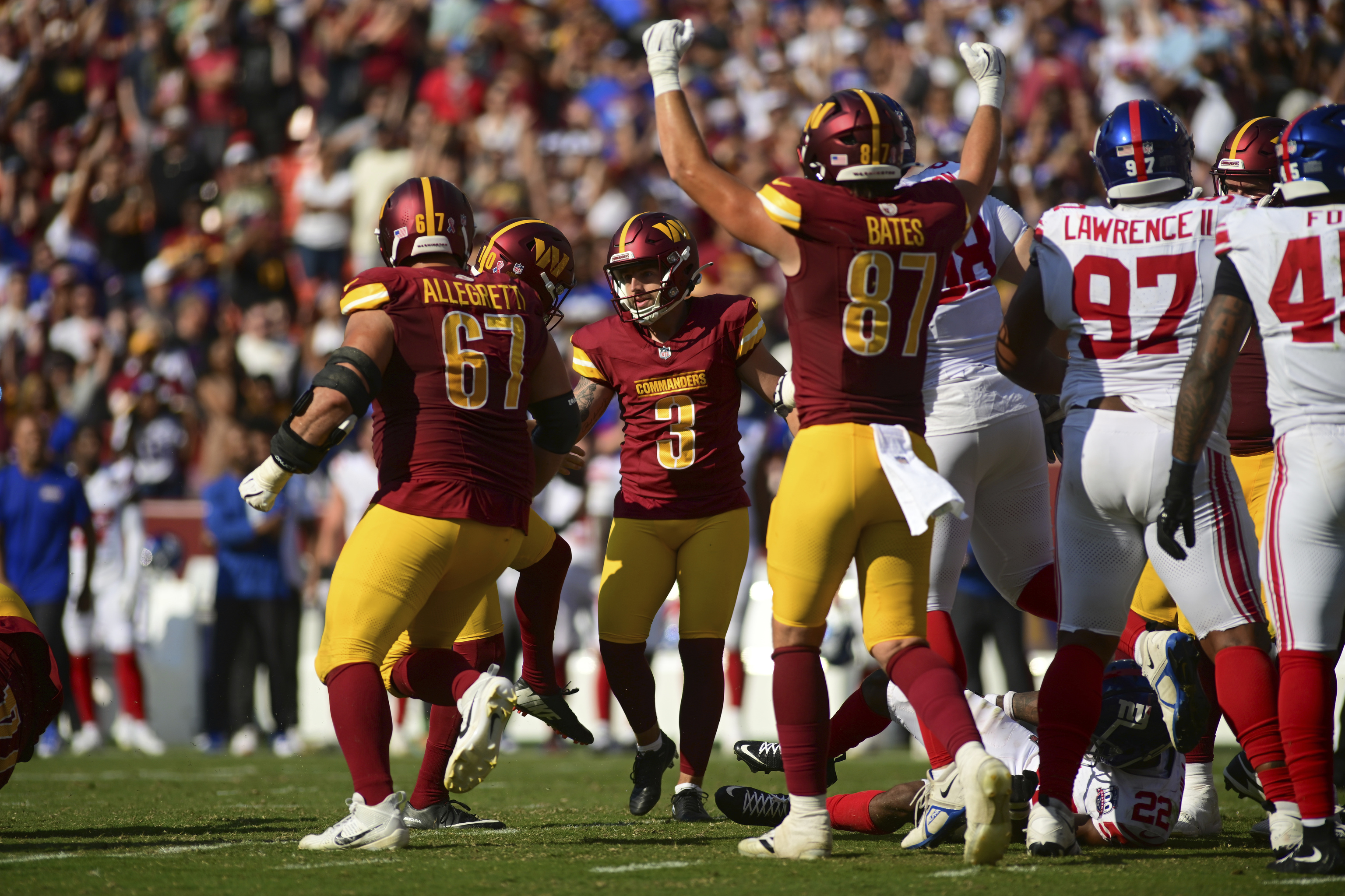 Washington Commanders place kicker Austin Seibert (3) celebrates with teammate after kicking the game-winning field goal against the New York Giants.