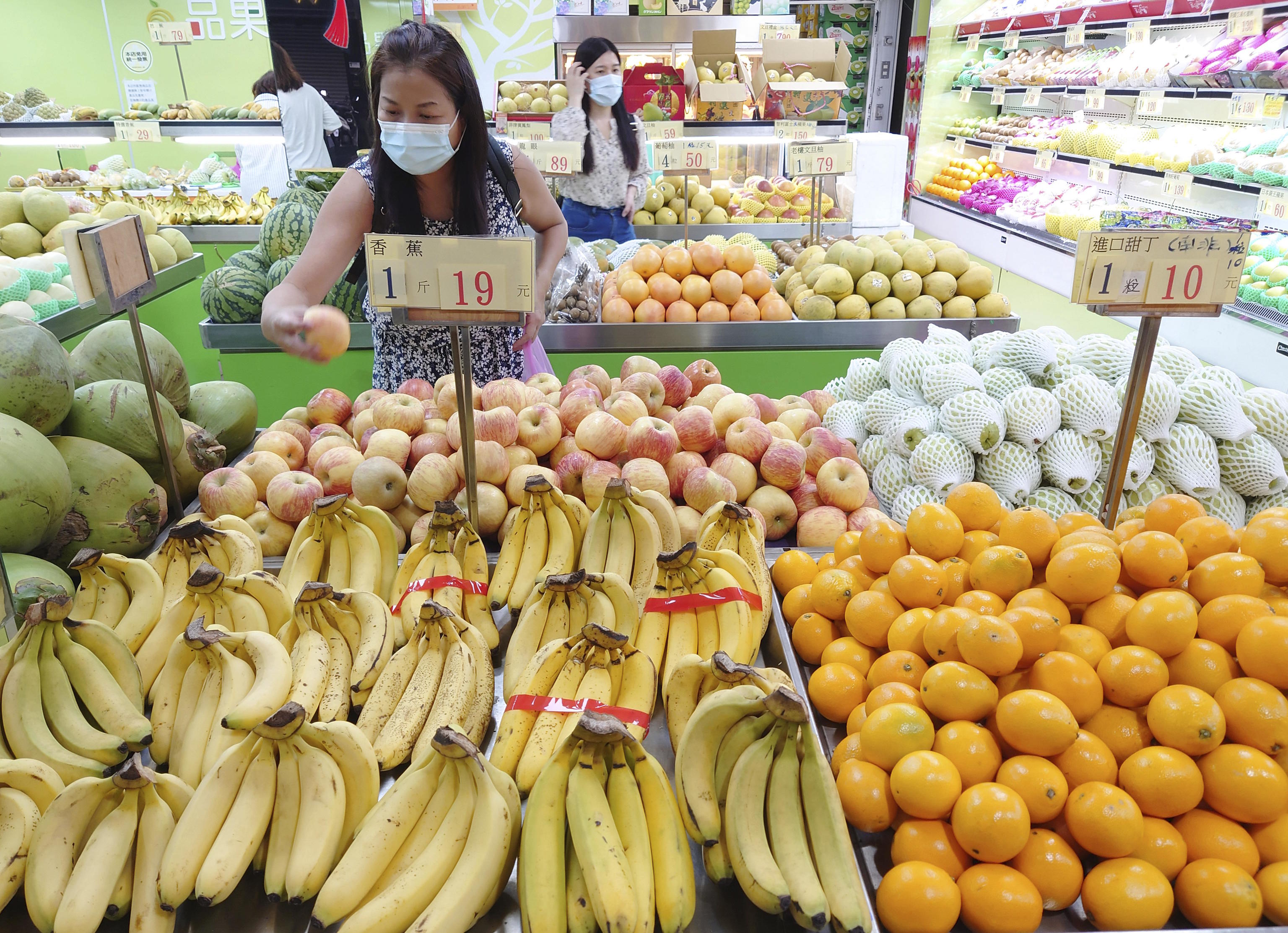 People buy fruit at a stall in Taipei.