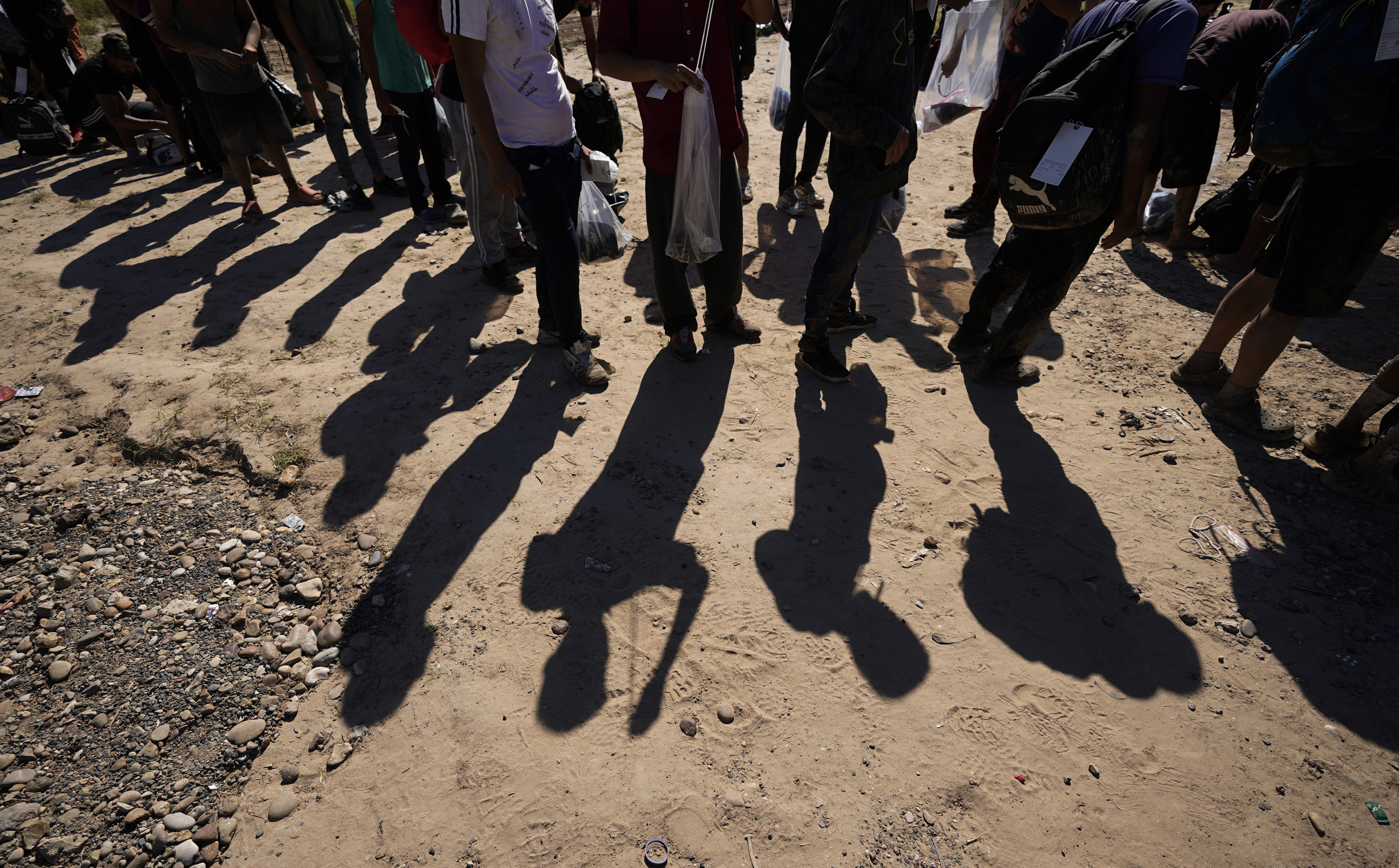 Migrants wait to be processed by the U.S. Customs and Border Patrol