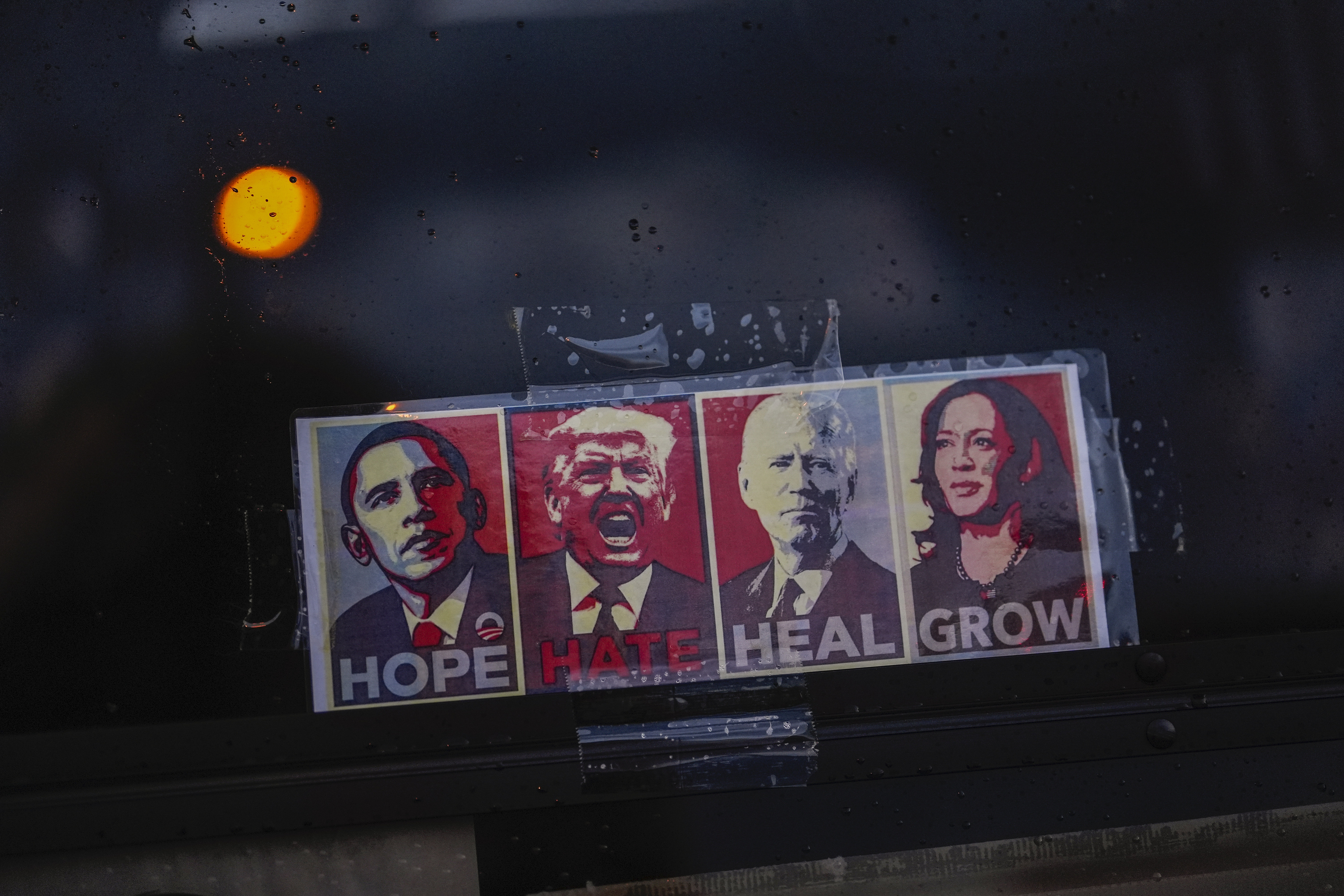 A sign depicting Democratic presidential nominee Vice President Kamala Harris alongside the three most recent presidents, from left, Barack Obama, Donald Trump, and Joe Biden, decorates a golf cart windshield