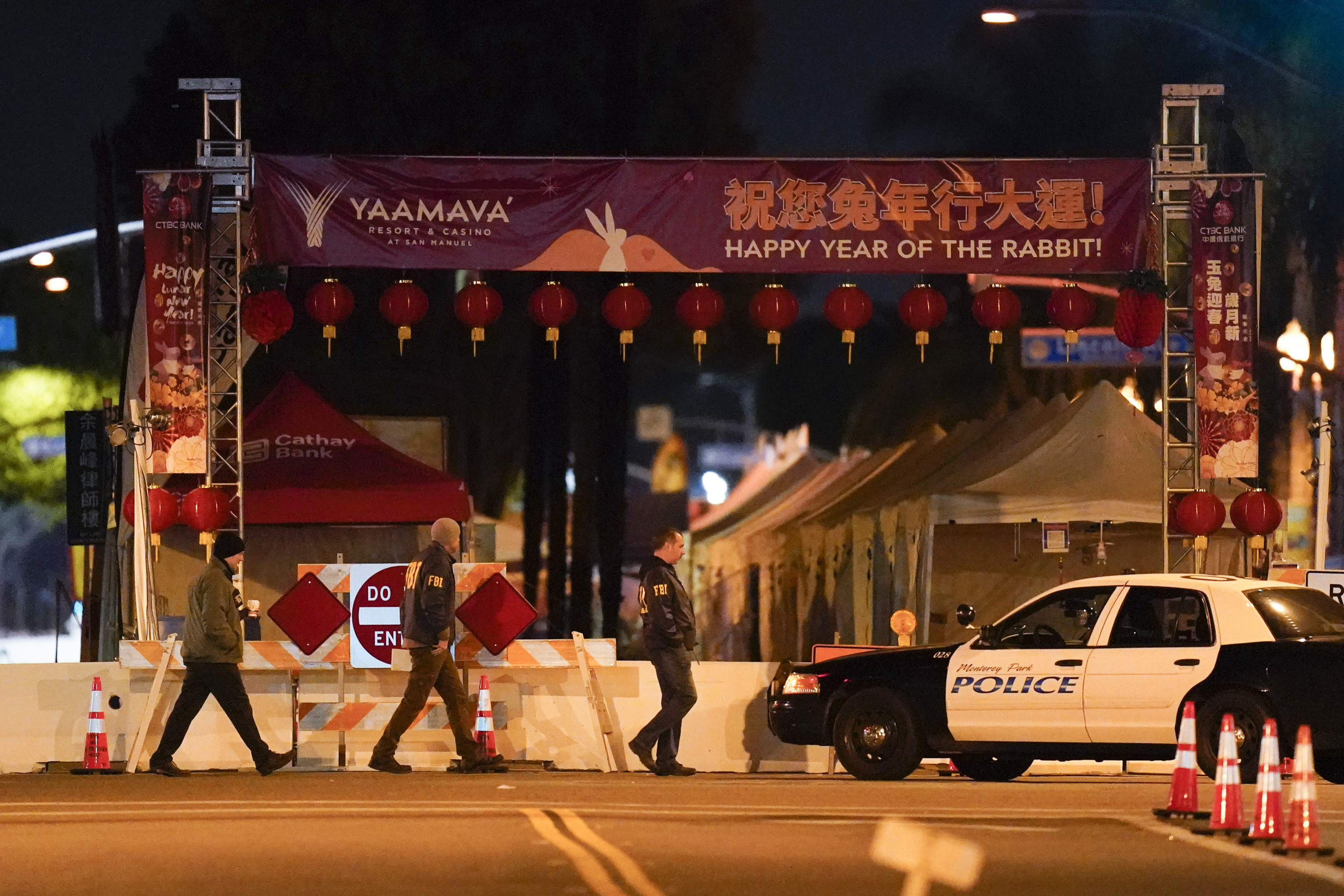 FBI agents walk near a scene where a shooting took place in Monterey Park