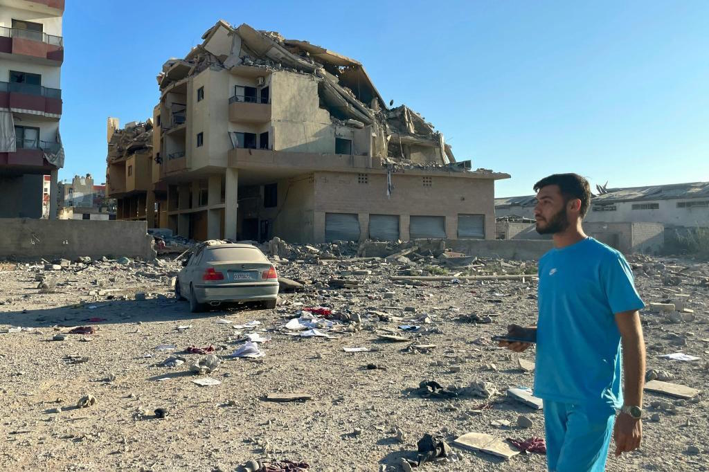 A man walks past destruction caused by Israeli airstrikes in southern Lebanon.