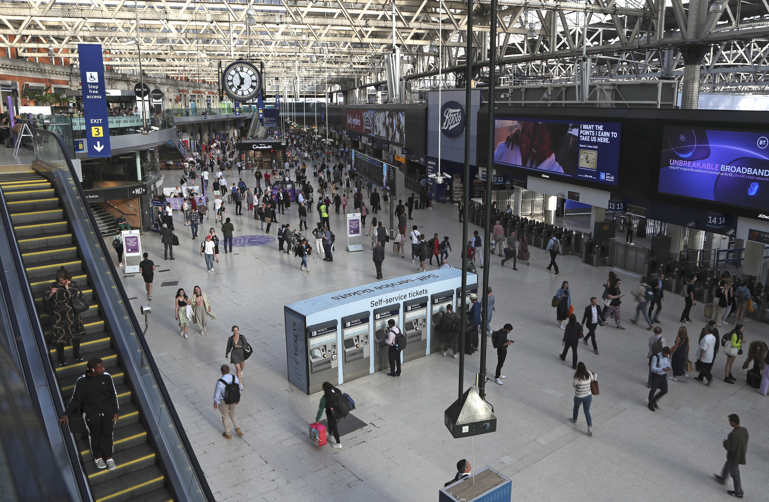 Commuters walk inside Waterloo station in London