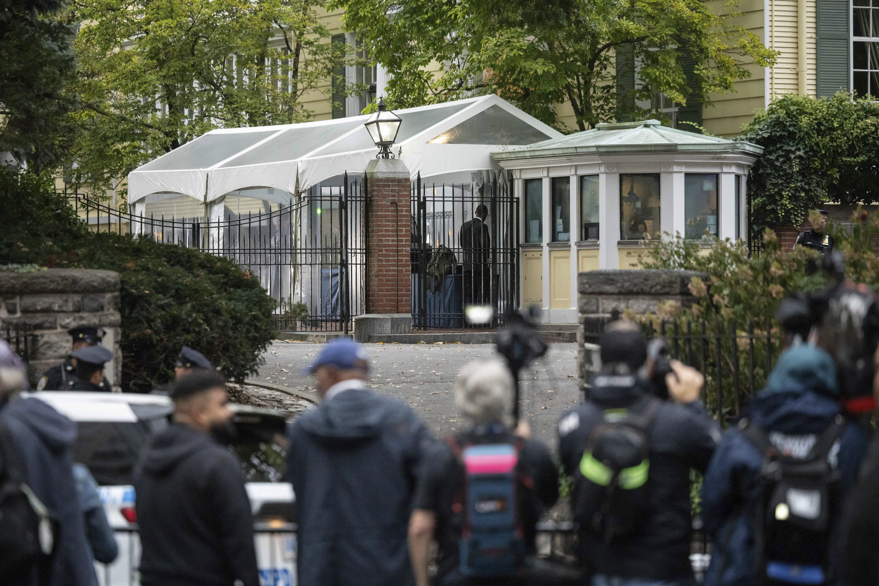 Members of the media gather outside Gracie Mansion, the official residence of New York City Mayor Eric Adams